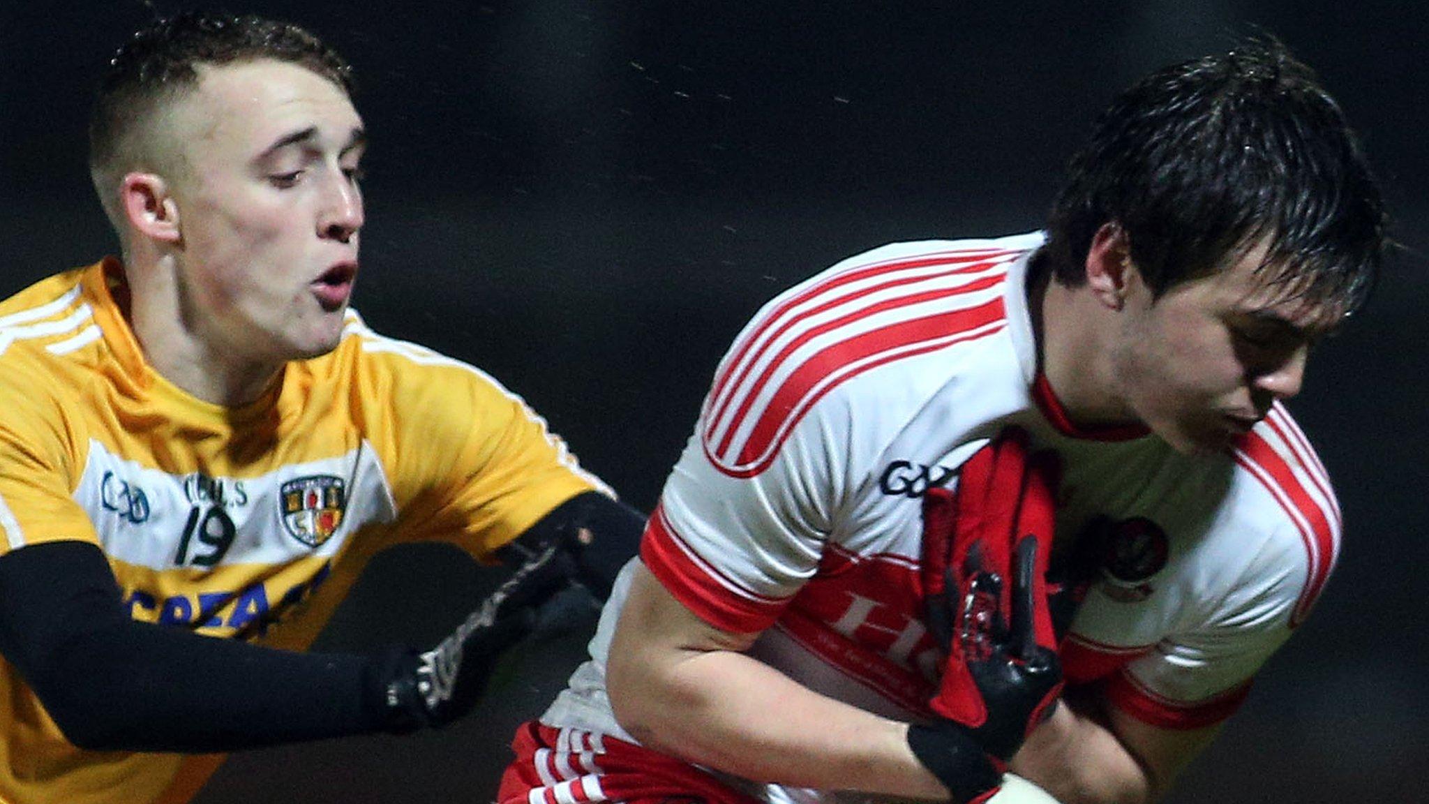 Derry's Oisin Duffy is challenged by Antrim's Seamus McGarry at Celtic Park