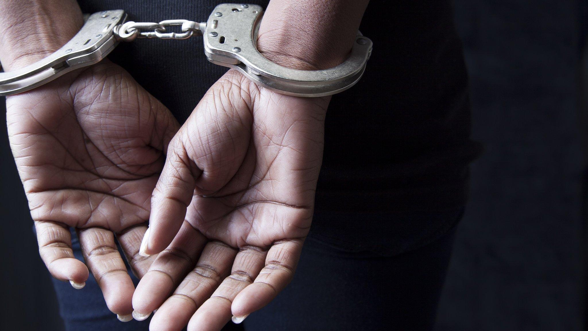 Stock image of hands in handcuffs