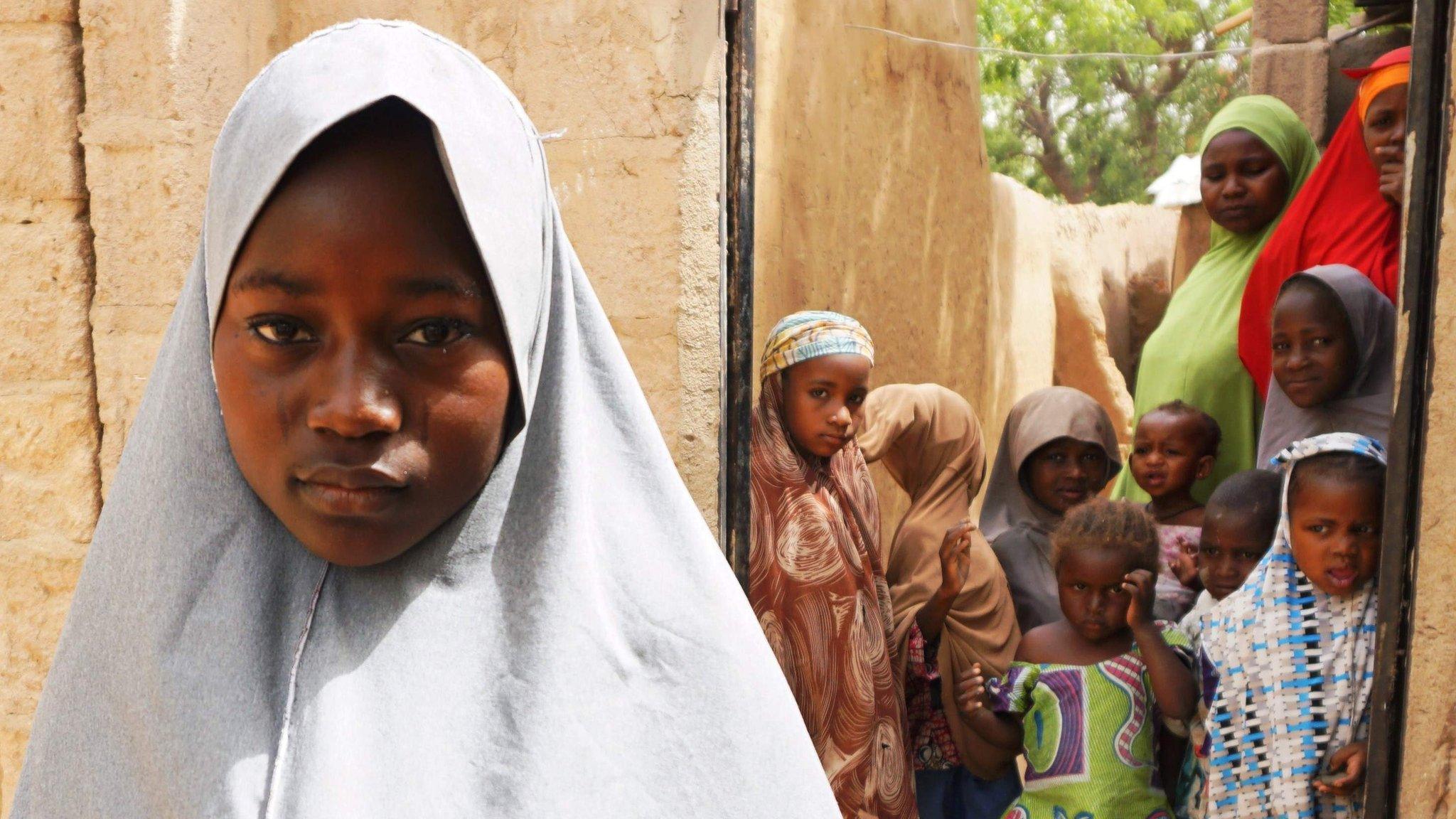 A girl who ran from the militants poses for the camera