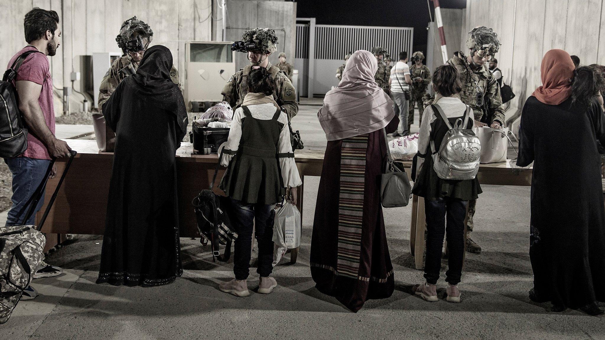 Afghans being checked by the US military on the way to an evacuation flight, Kabul (27 August)