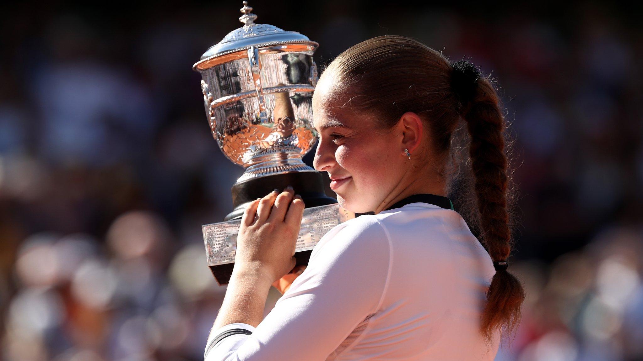 Jelena Ostapenko of Latvia lifts the Suzanne Lenglen Cup