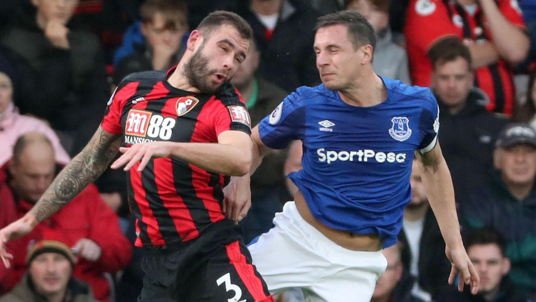 Phil Jagielka (right) challenges for a header