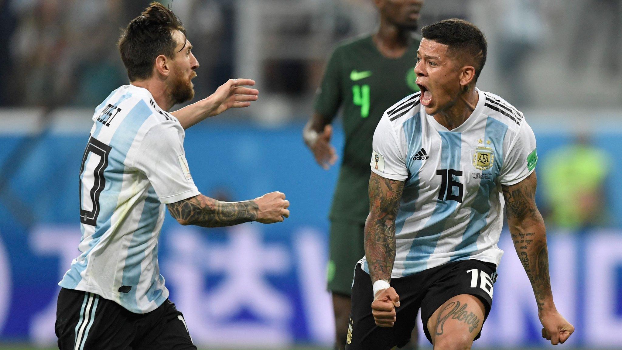 Lionel Messi celebrates with Marcos Rojo after the latter's late winner for Argentina