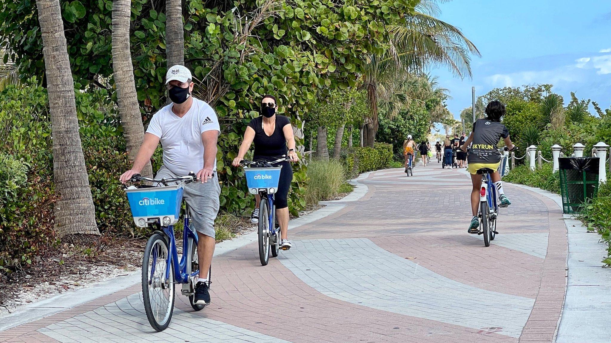 Florida tourists in masks biking