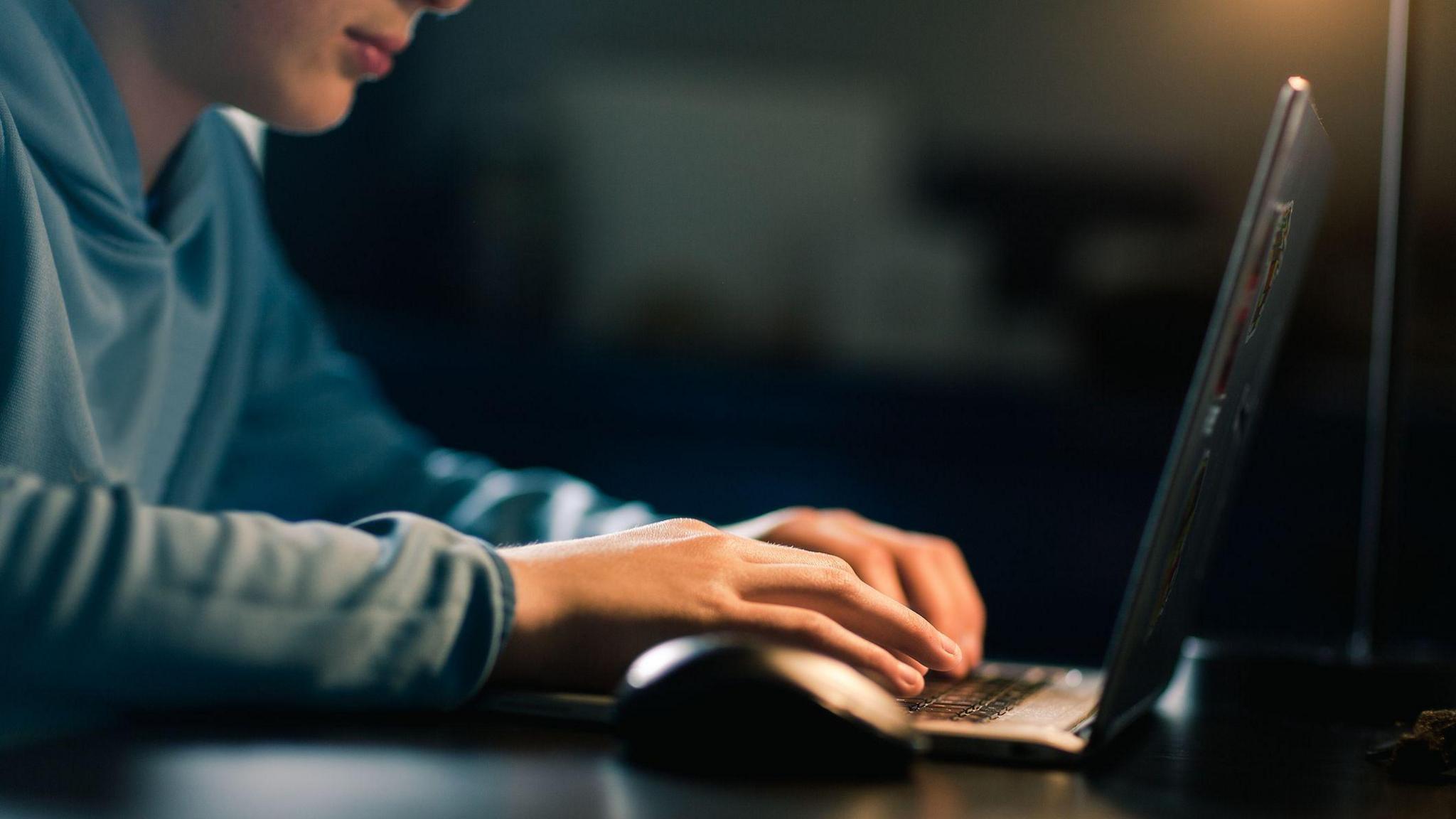 Teenage boy using computer