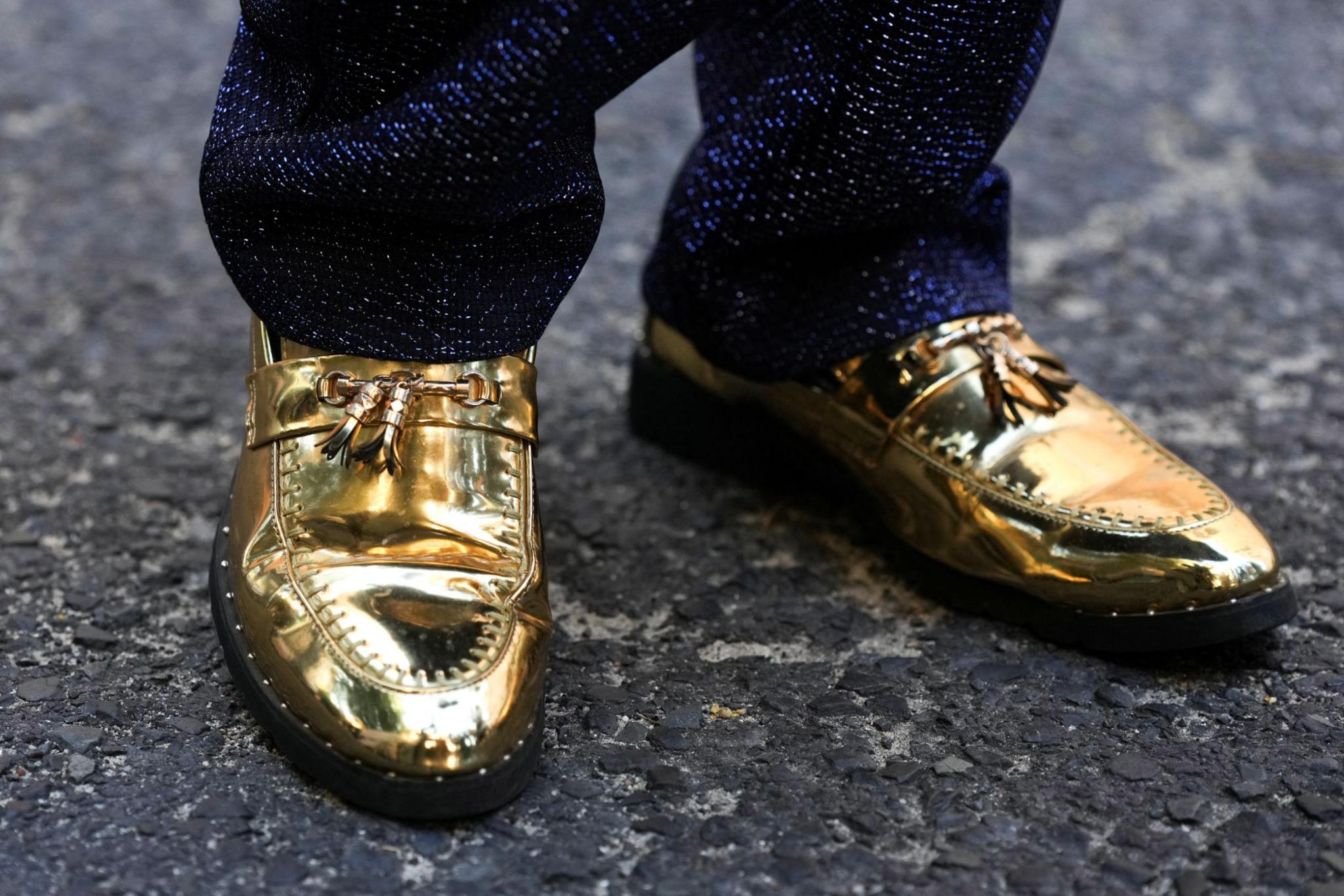 A close-up image of shiny gold shoes.