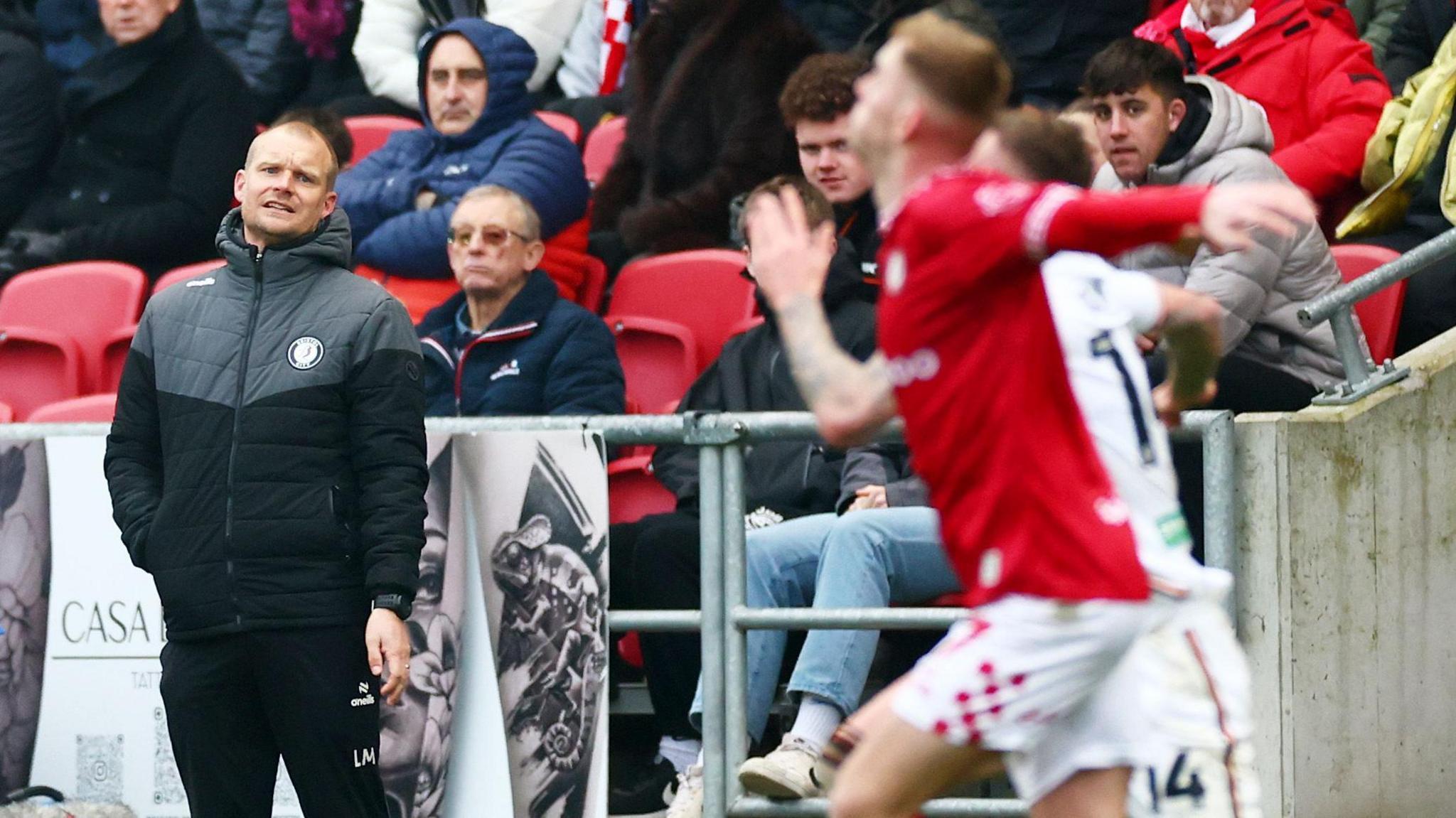 Liam Manning looks on from the touchline at Ashton Gate