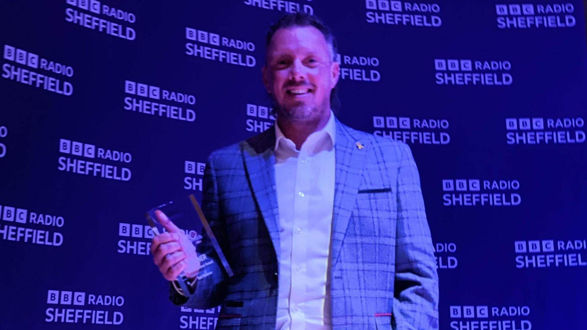 A man holding an award