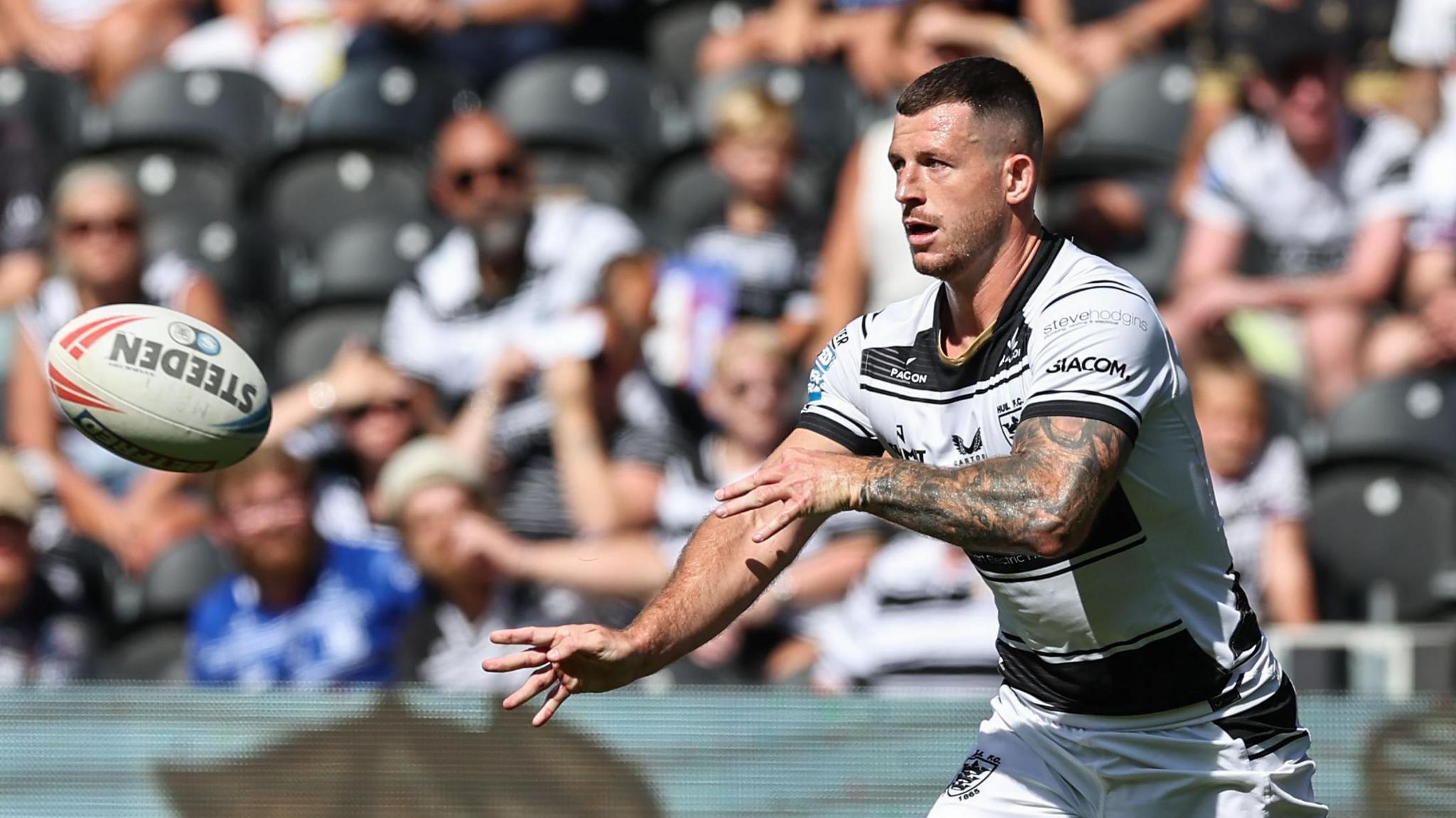 Hull FC player Cade Cust throwing a pass during their recent game with Salford Red Devils at MKM Stadium  