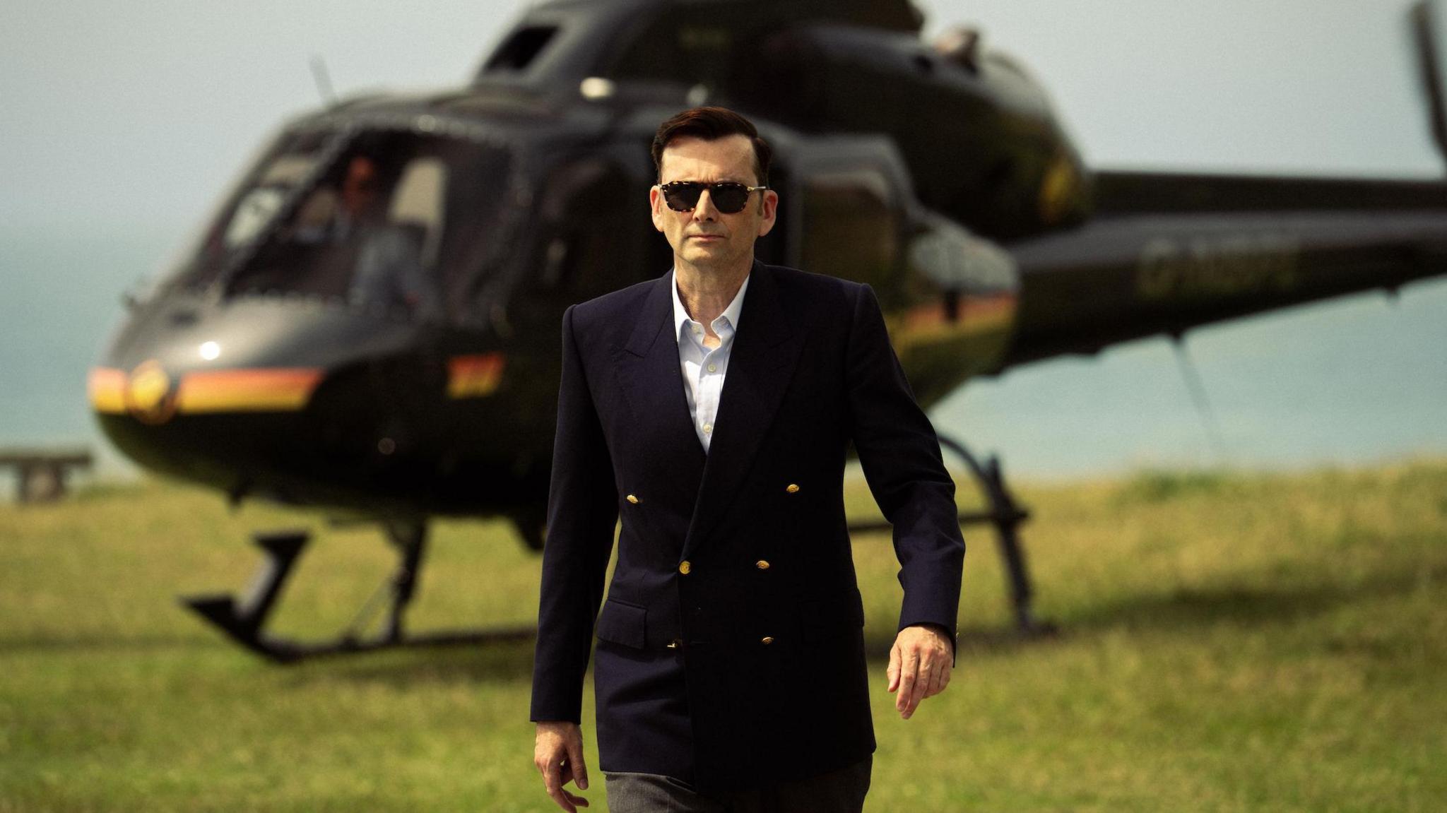David Tennant's Tony Baddingham striding away from a helicopter