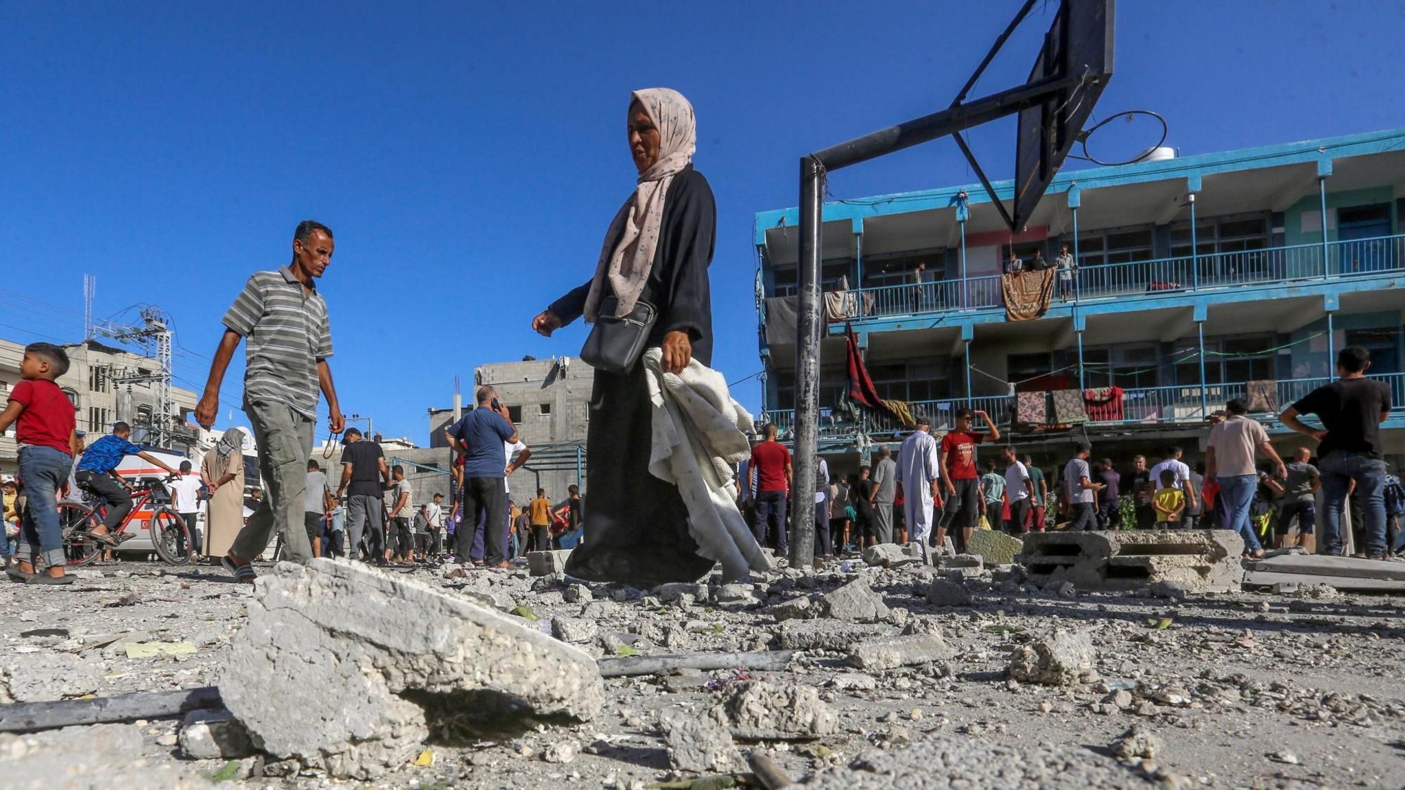 Palestinians inspect damage to part of the UN-run al-Jaouni school in Nuseirat refugee camp, in central Gaza, following an Israeli air strike (11 September 2024)