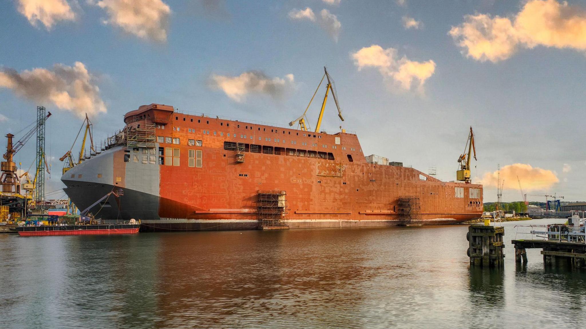 A large ship under construction at a shipyard