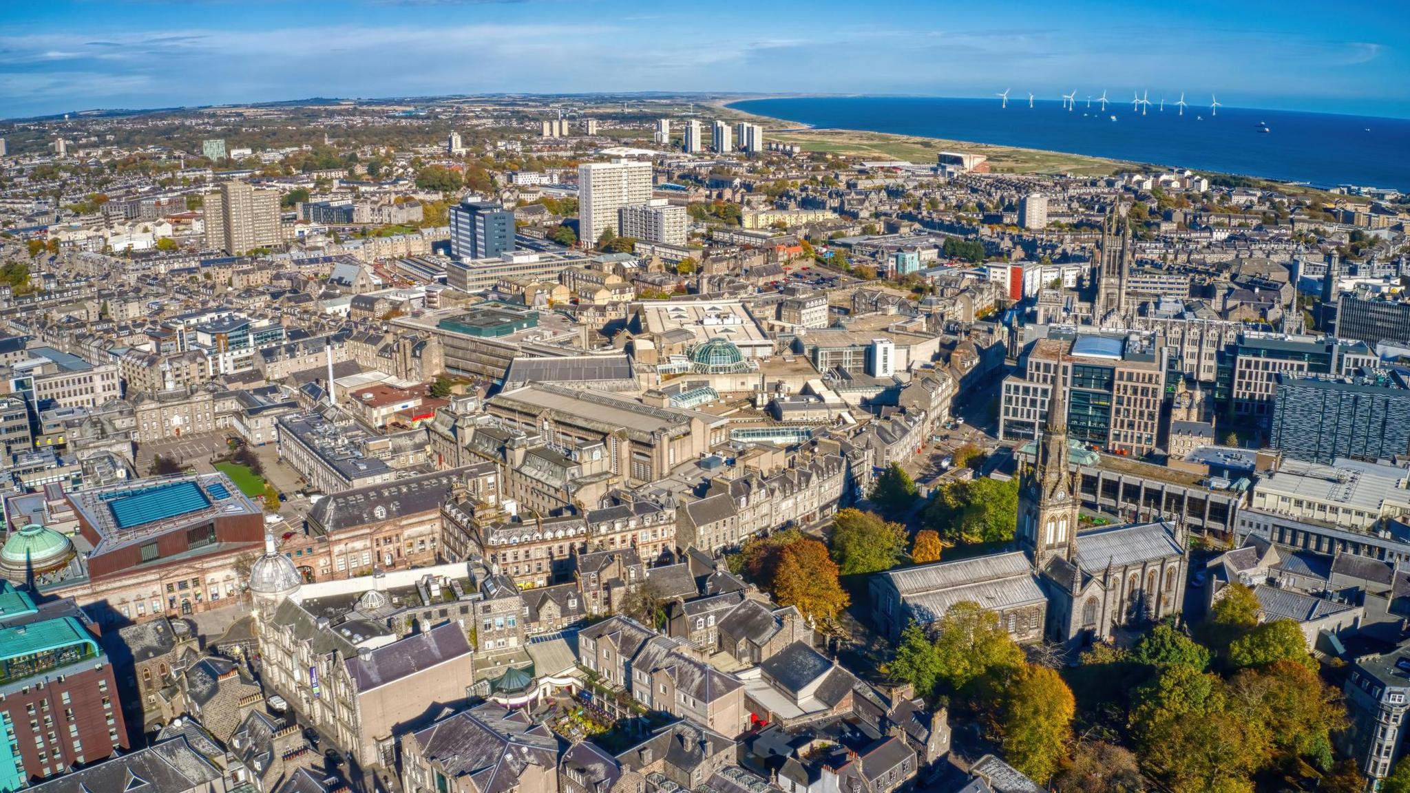 An aerial of view of the city of Aberdeen and the North Sea beyond.