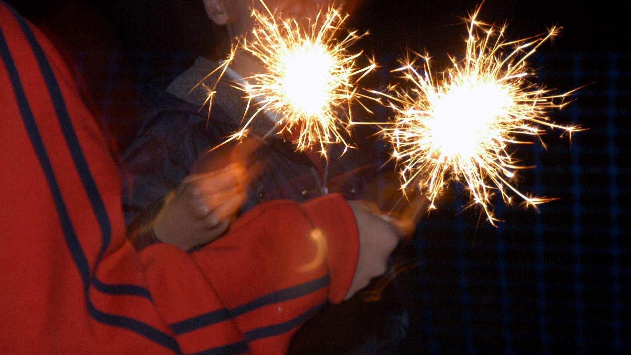 Children playing with sparklers