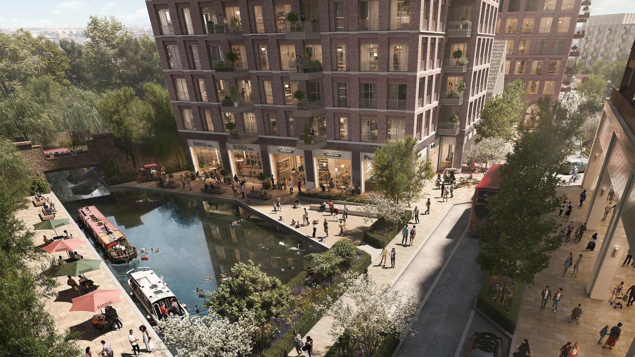 A CGI visualisation of a canal-side area showing pedestrians walking beside moored boats, outdoor café seating with umbrellas, and brick apartment buildings with shops and balconies overlooking the water.