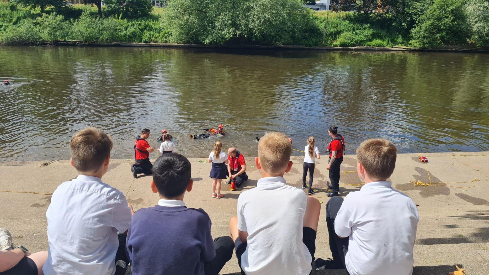 Children watching a water safety demonstration