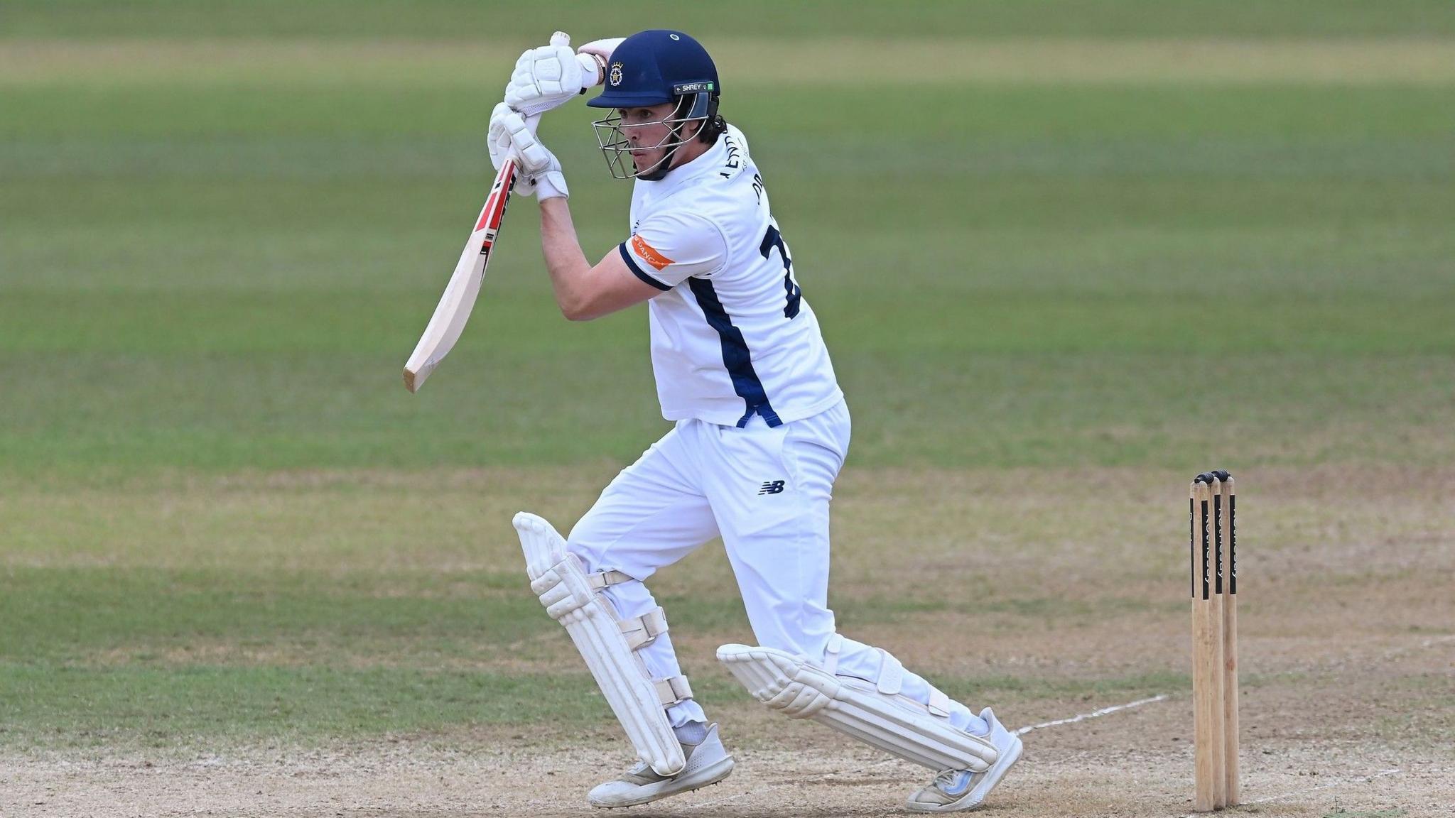 Left-handed Hampshire opener Ali Orr plays off-drive, wearing whits and Hampshire blue club helmet.