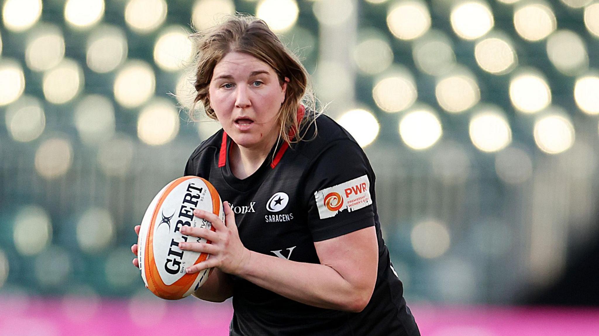 Saracens player Poppy Cleall with a rugby ball