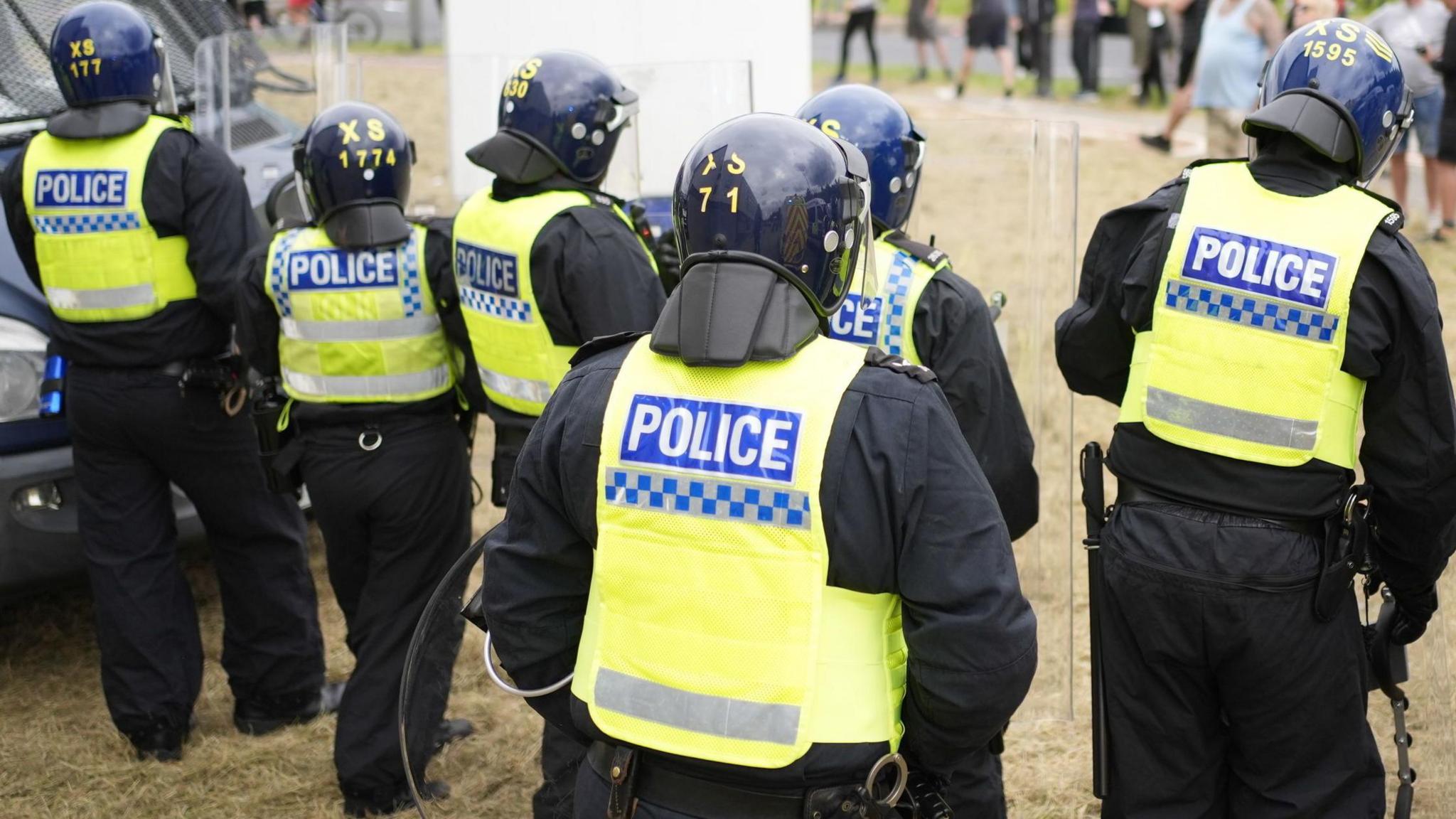 Riot police outside asylum seekers' accommodation in northern England during disorder this summer