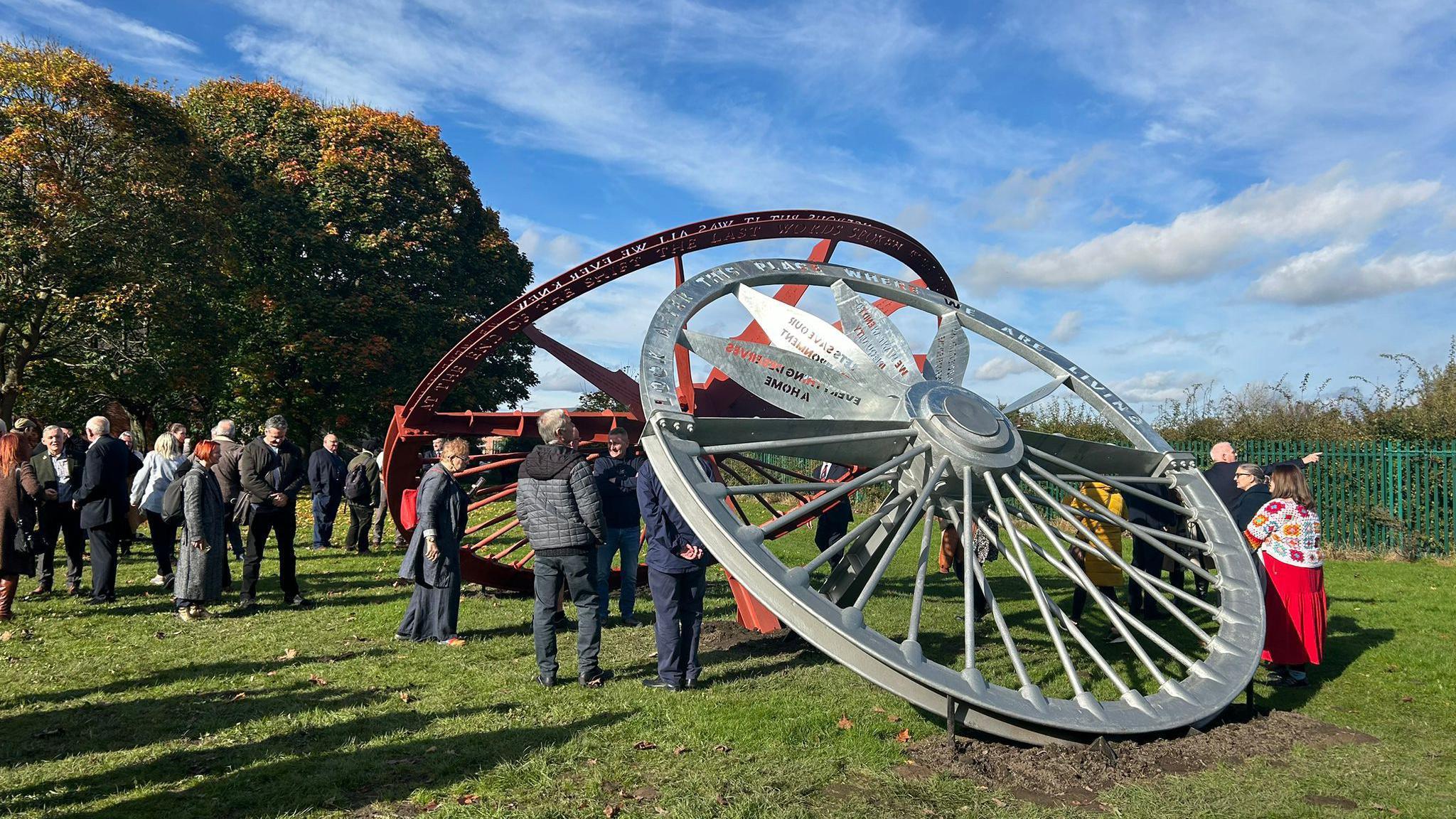 People gather around the sculpture in Featherstone for the unveiling 