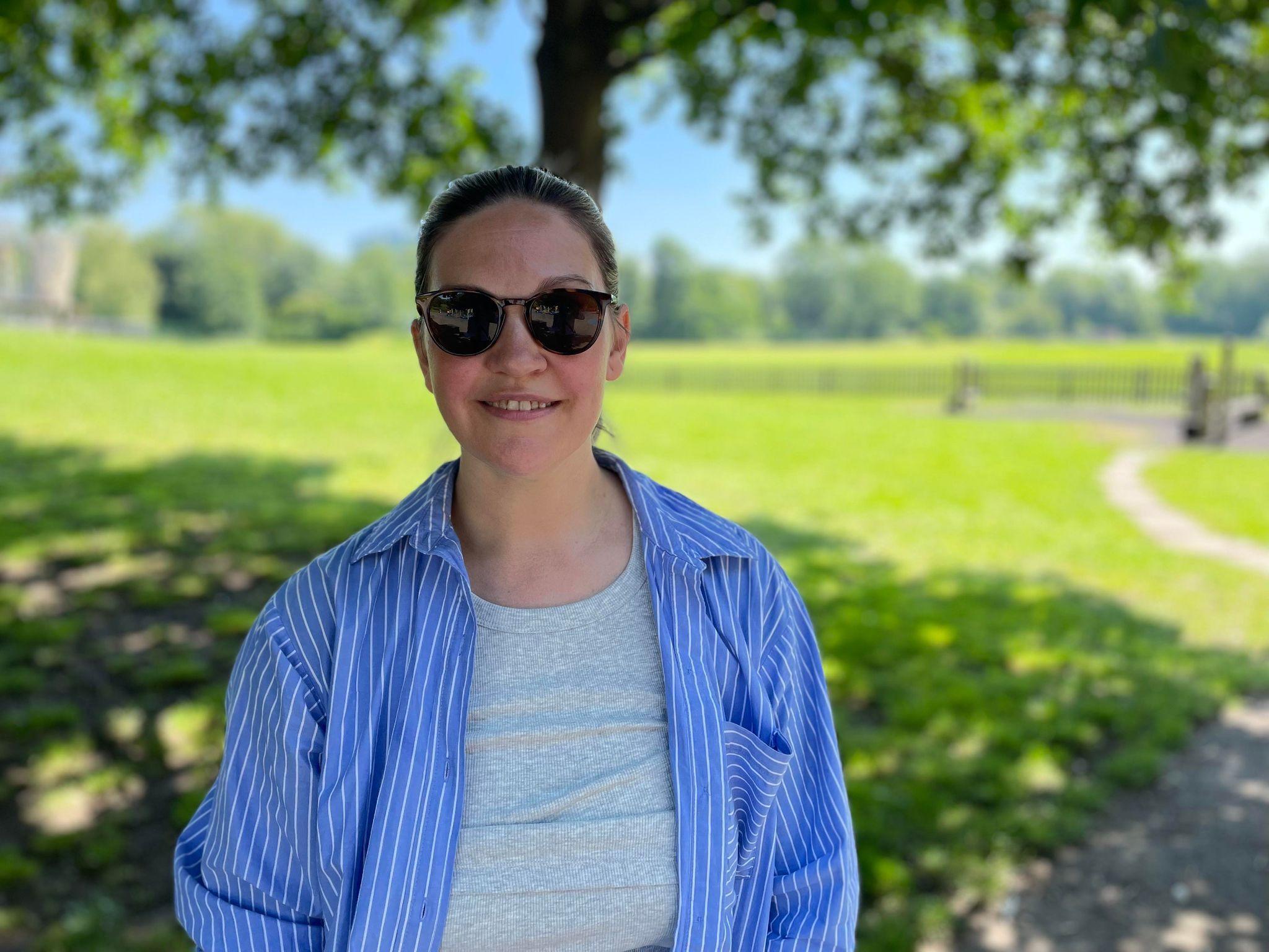 A woman in sunglasses standing in Markeaton Park