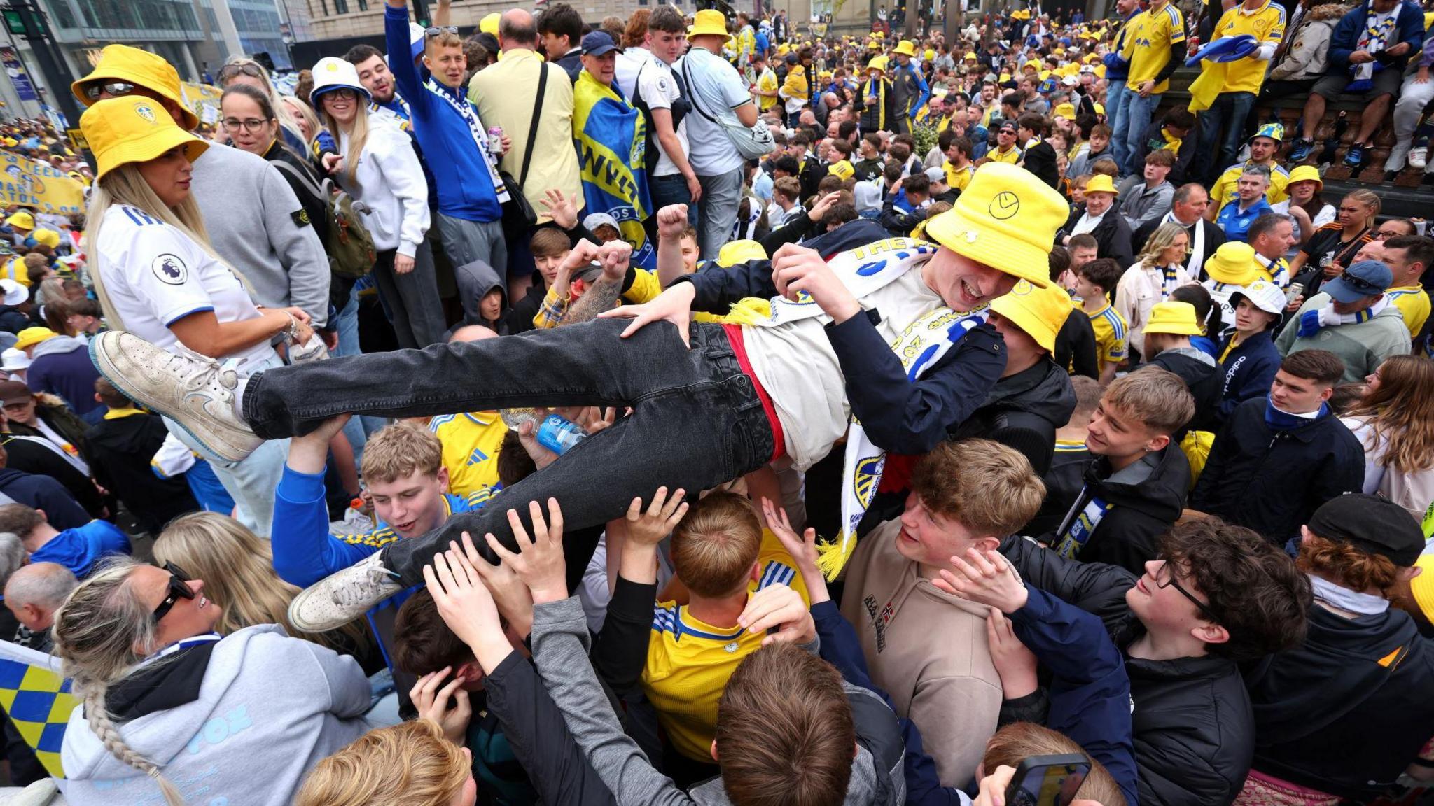 Fan crowdsurfs in the crowd of other fans 