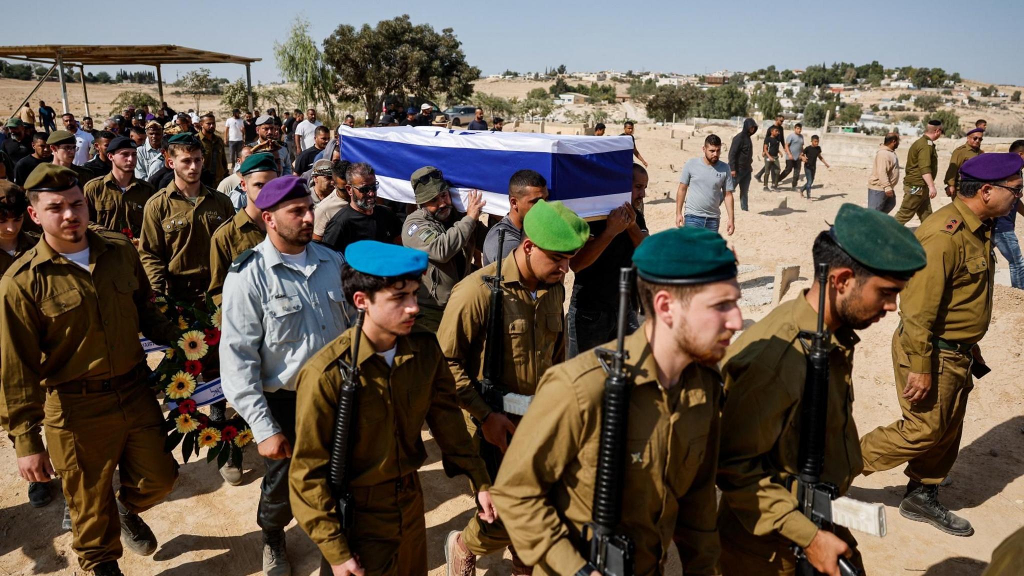Israeli soldiers accompany the coffin of Sgt Maj Muhammad al-Atarash, who was killed in the 7 October attack and whose body was held hostage in Gaza, at his funeral in Sawa, southern Israel (16 October 2025)