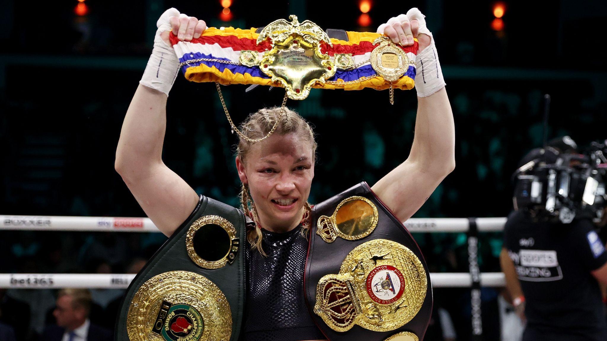 Lauren Price poses for photographs as she celebrates victory with her belts after defeating Jessica McCaskill in their IBO and WBA world welterweight title fight 