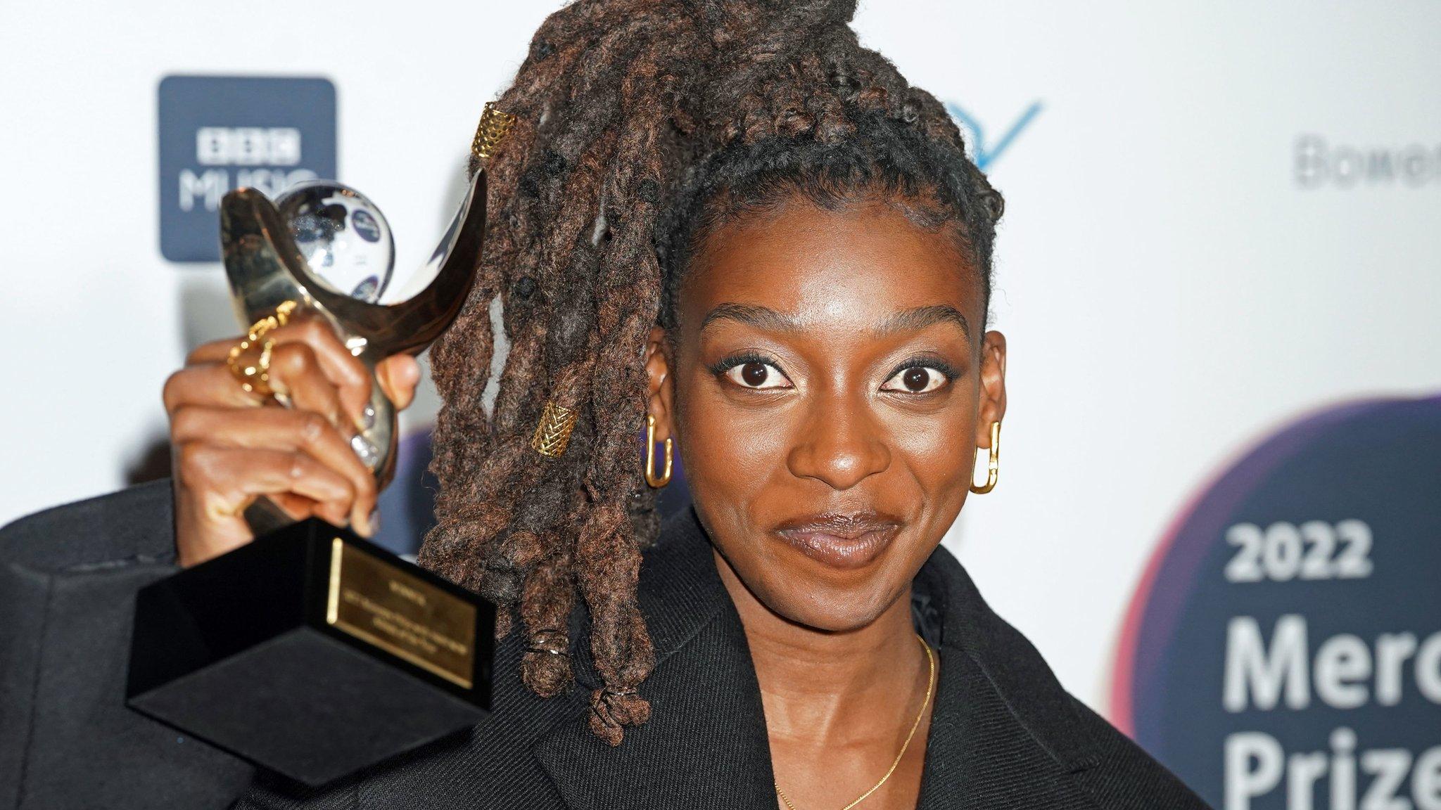 Little Simz holding Mercury award