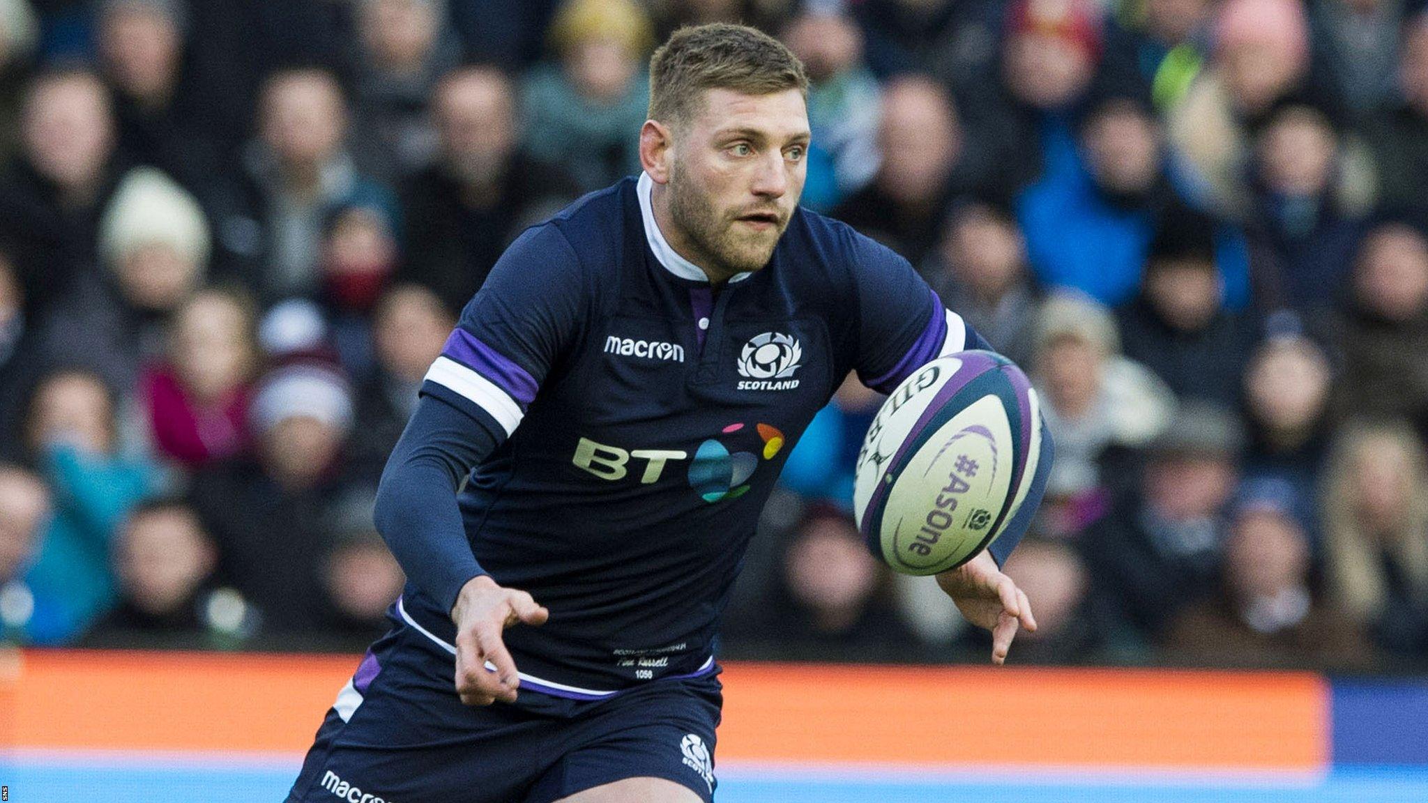 Finn Russell plays a pass for Scotland against Australia