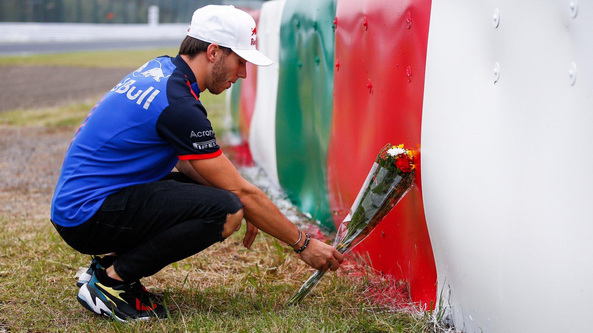 Pierre Suzuka, Japan, 4 October: Toro Rosso driver Pierre Gasly lays flowers in memory of childhood friend Jules Bianchi ahead of the Japanese Grand Prix. Bianchi suffered a crash at the circuit in 2014 and died nine months later. (Photo by Andy Hone/LAT Images/REX/Shutterstock)