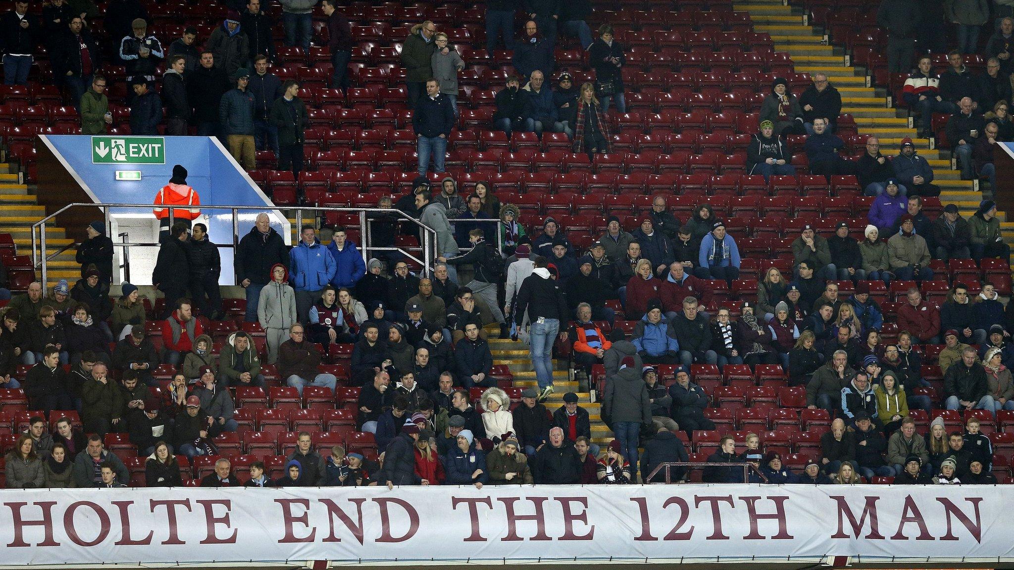 Aston Villa fans head for the exits during the match against Everton