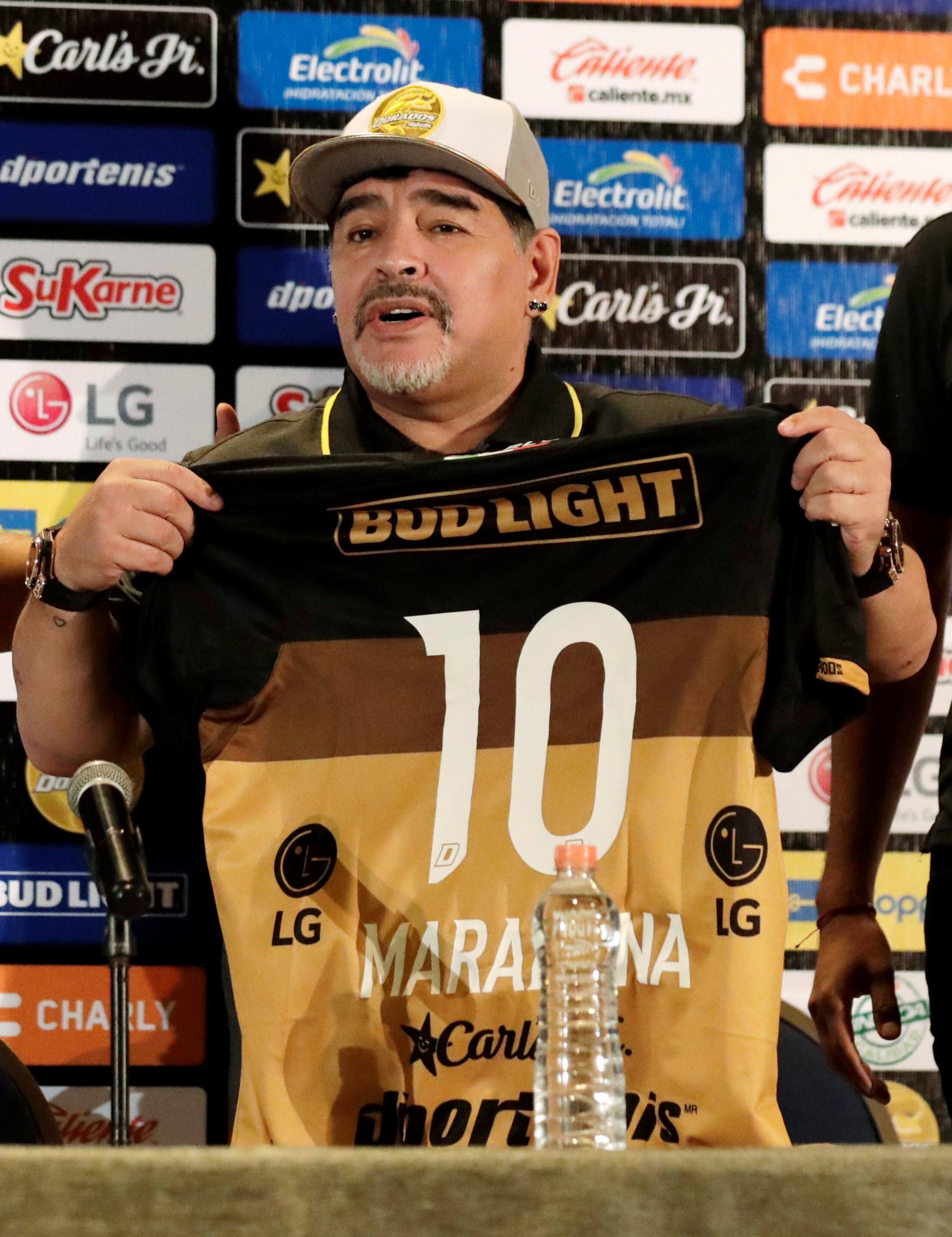 Diego Maradona holds a shirt of the Dorados team with the number 10 on during a press conference, in Culiacan, Sinaloa, Mexico, 10 September 2018.