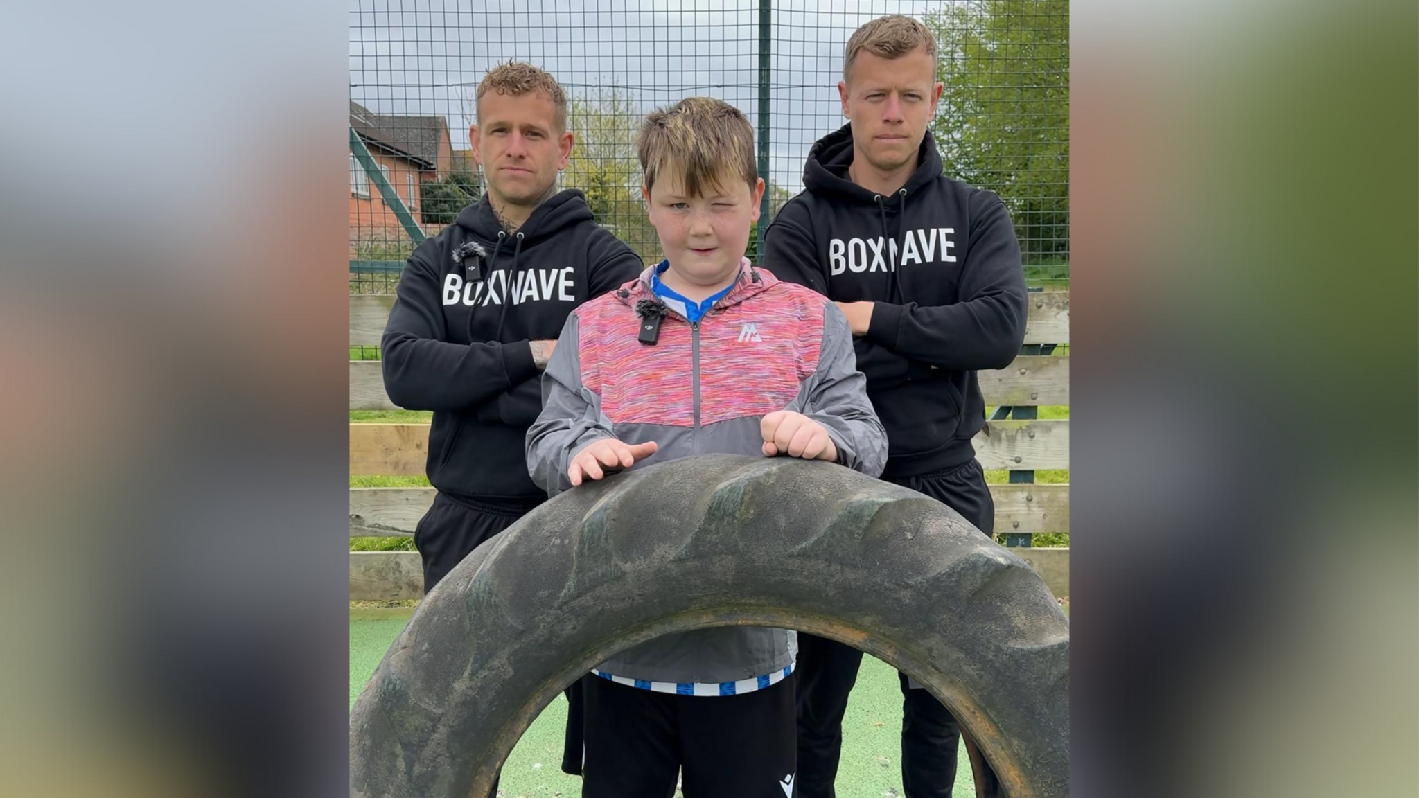 Harry and Joe Freeman stood in branded Boxwave hoodies, arms crossed, either side of Liam.