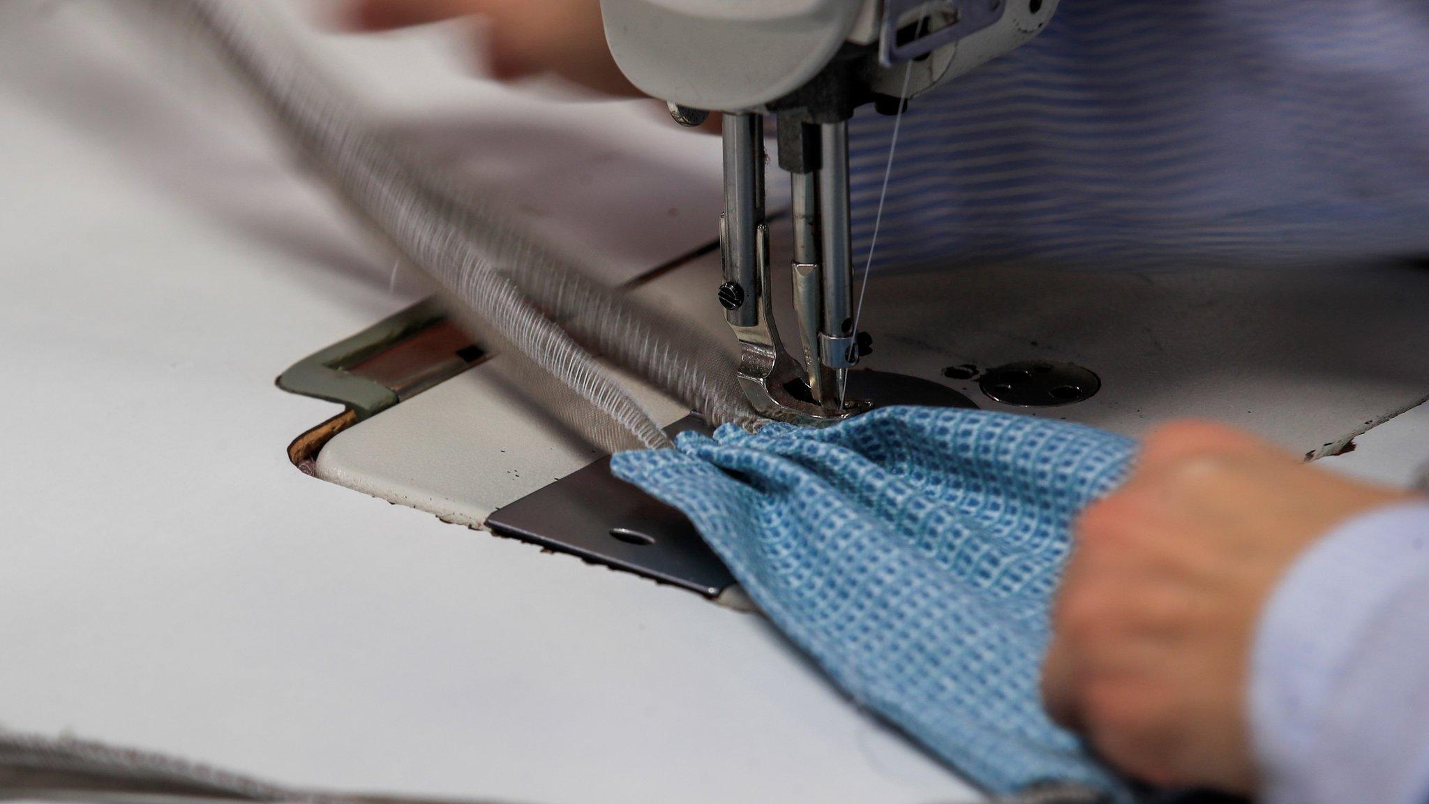 An employee sews pleats into a mask at NorthCape, an outdoor furniture upholstery manufacturer, in Alsip, Illinois, USA, 31 March 2020