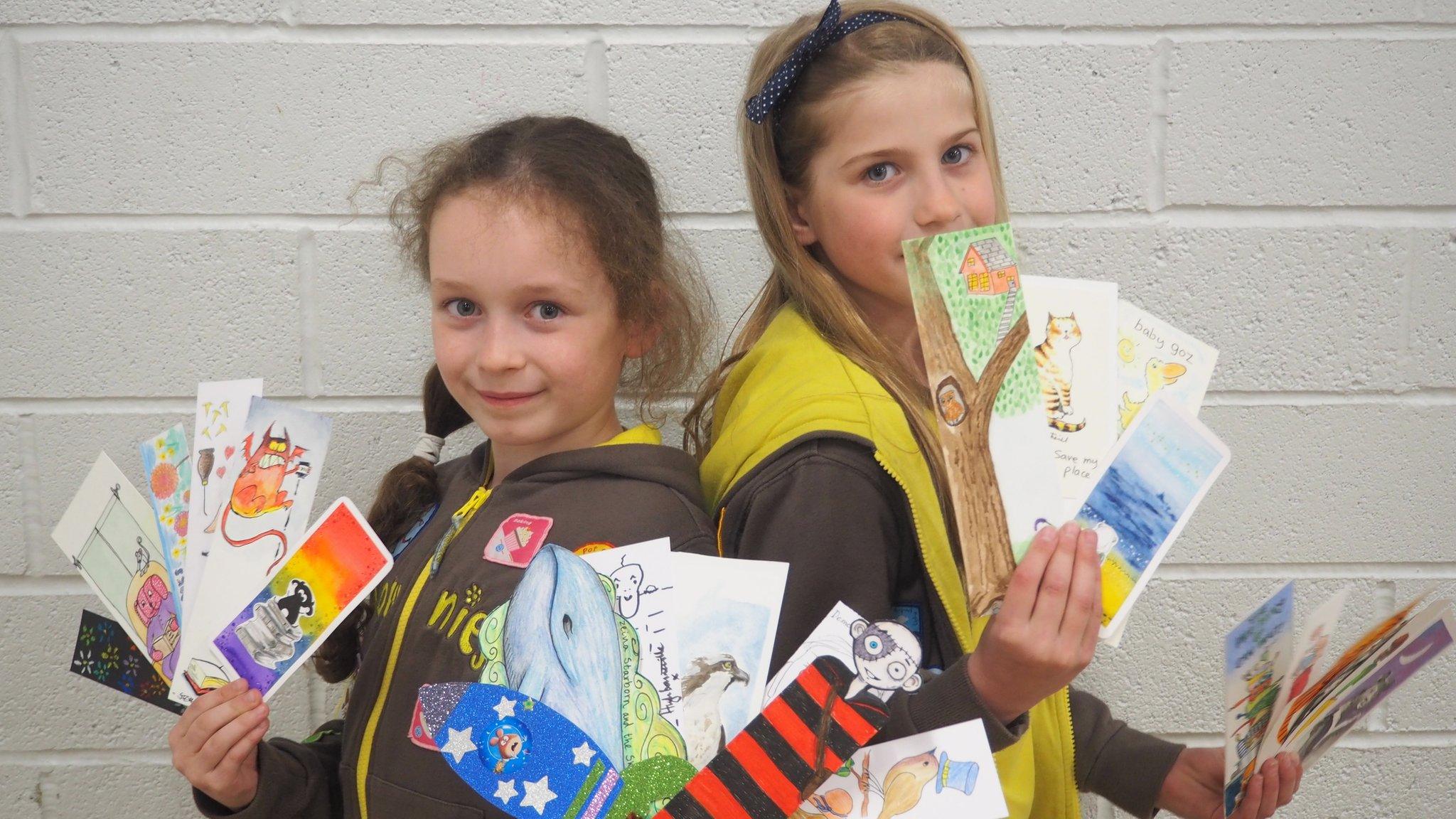 Brownies holding up celebrity bookmarks