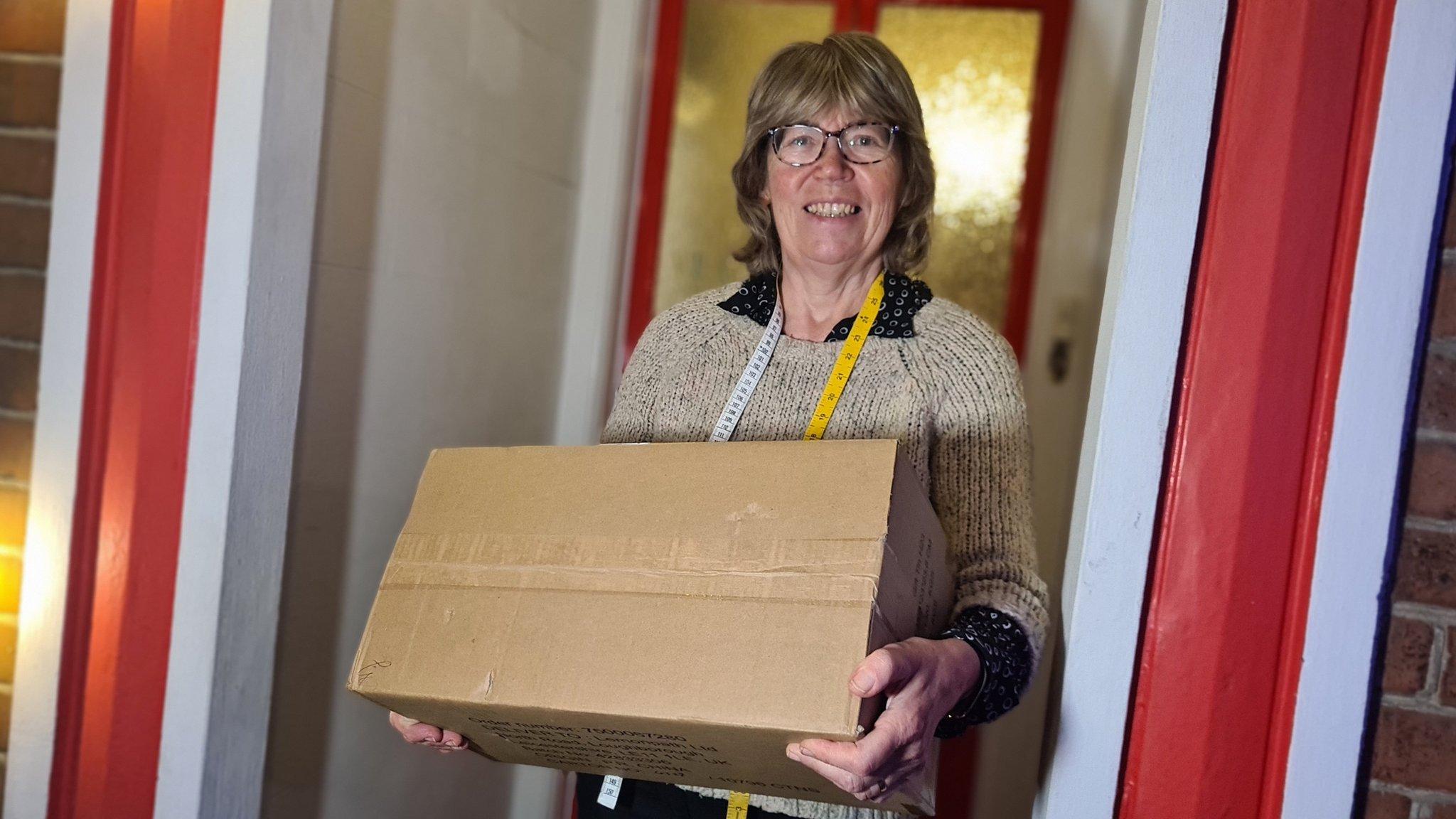 Colchester resident Jean Quinn holding a parcel.