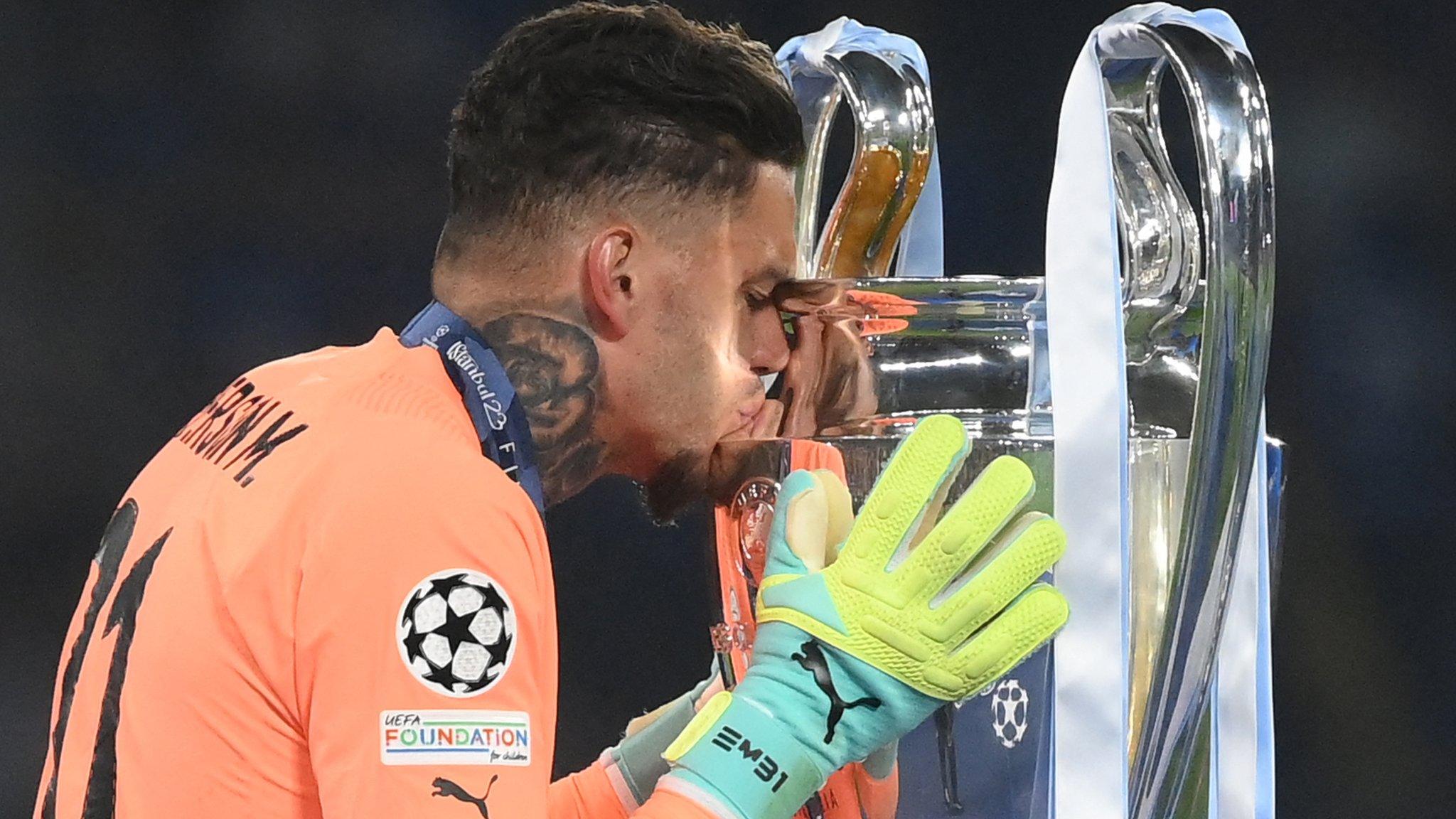 Ederson kisses the trophy