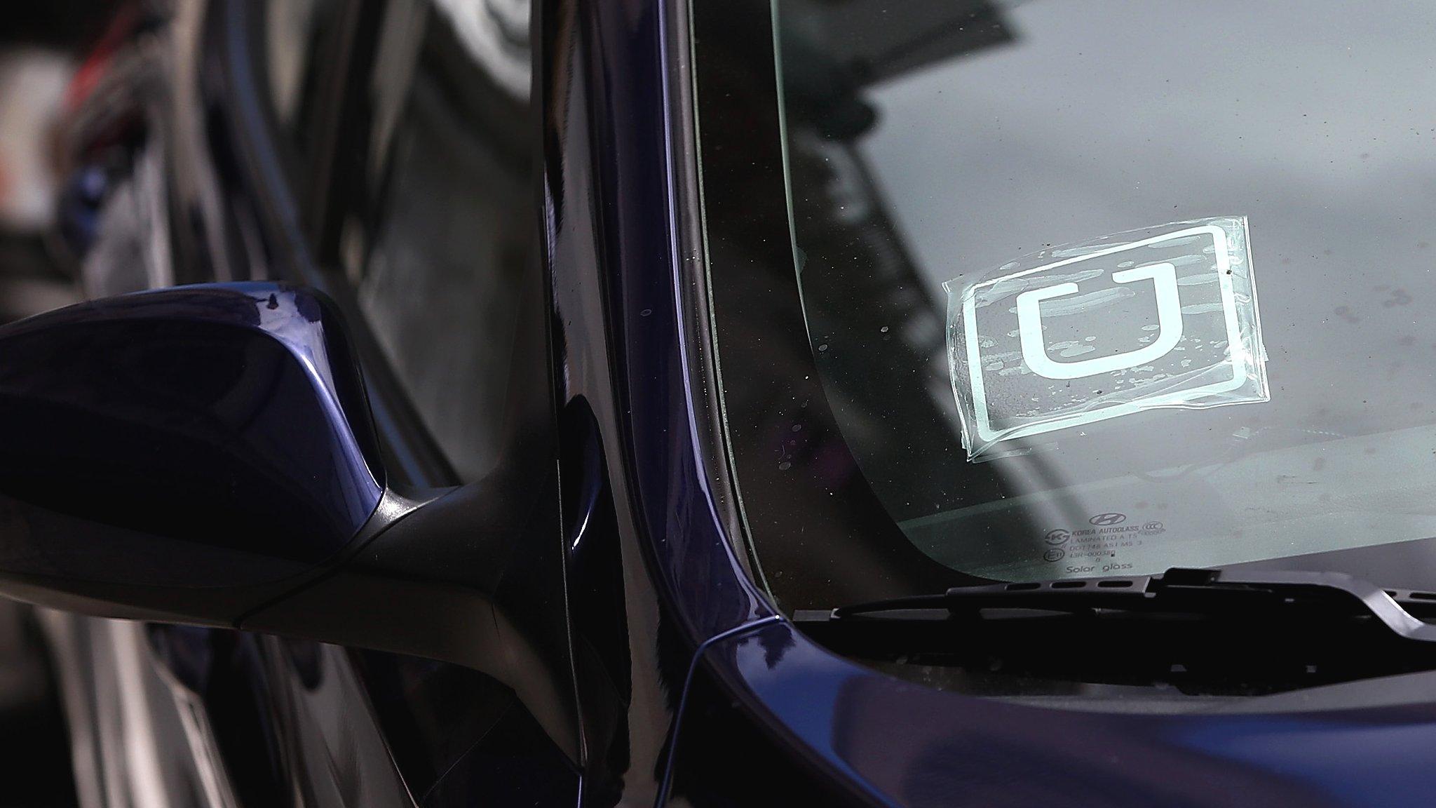 Uber sticker in car window