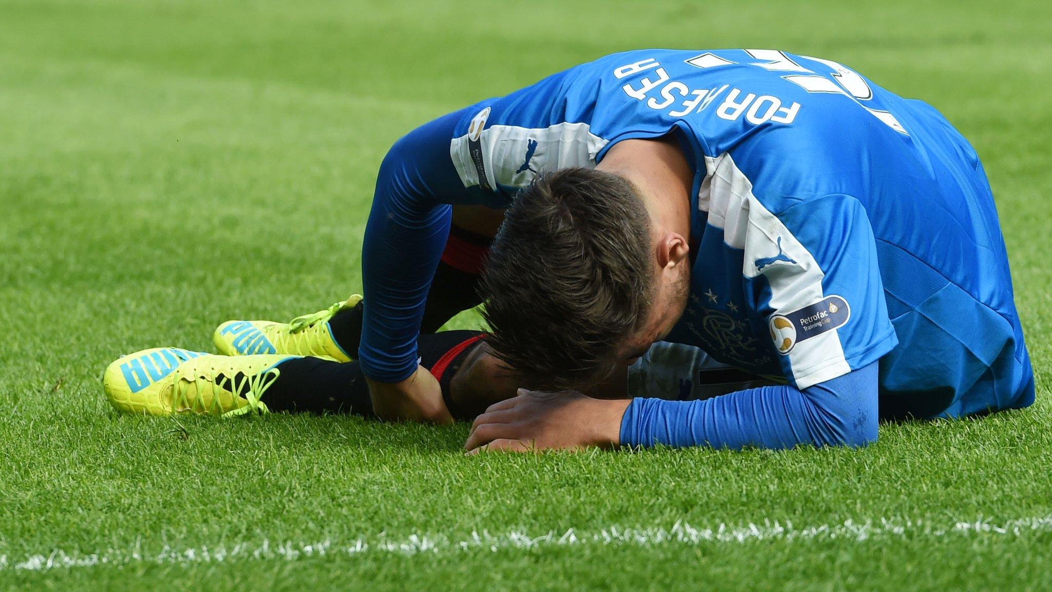 Rangers midfielder Harry Forrester lies injured at Hampden