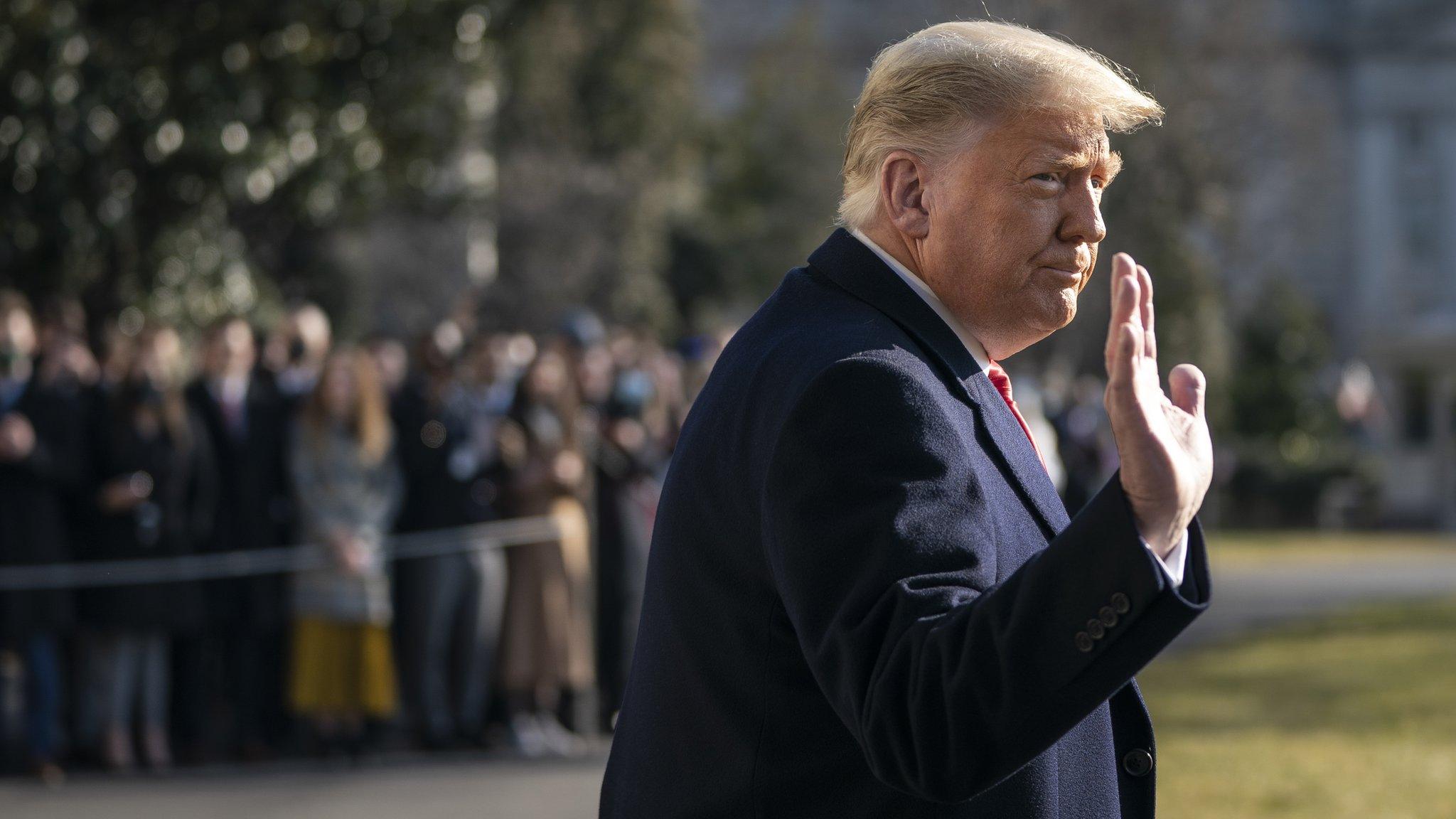 Donald Trump waves as he walks to Marine One on the South Lawn of the White House on 12 January