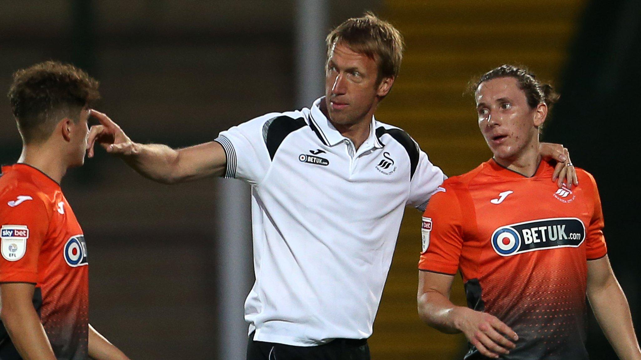 Swansea City Manager Graham Potter with his arm around Aaron Lewis of Swansea City
