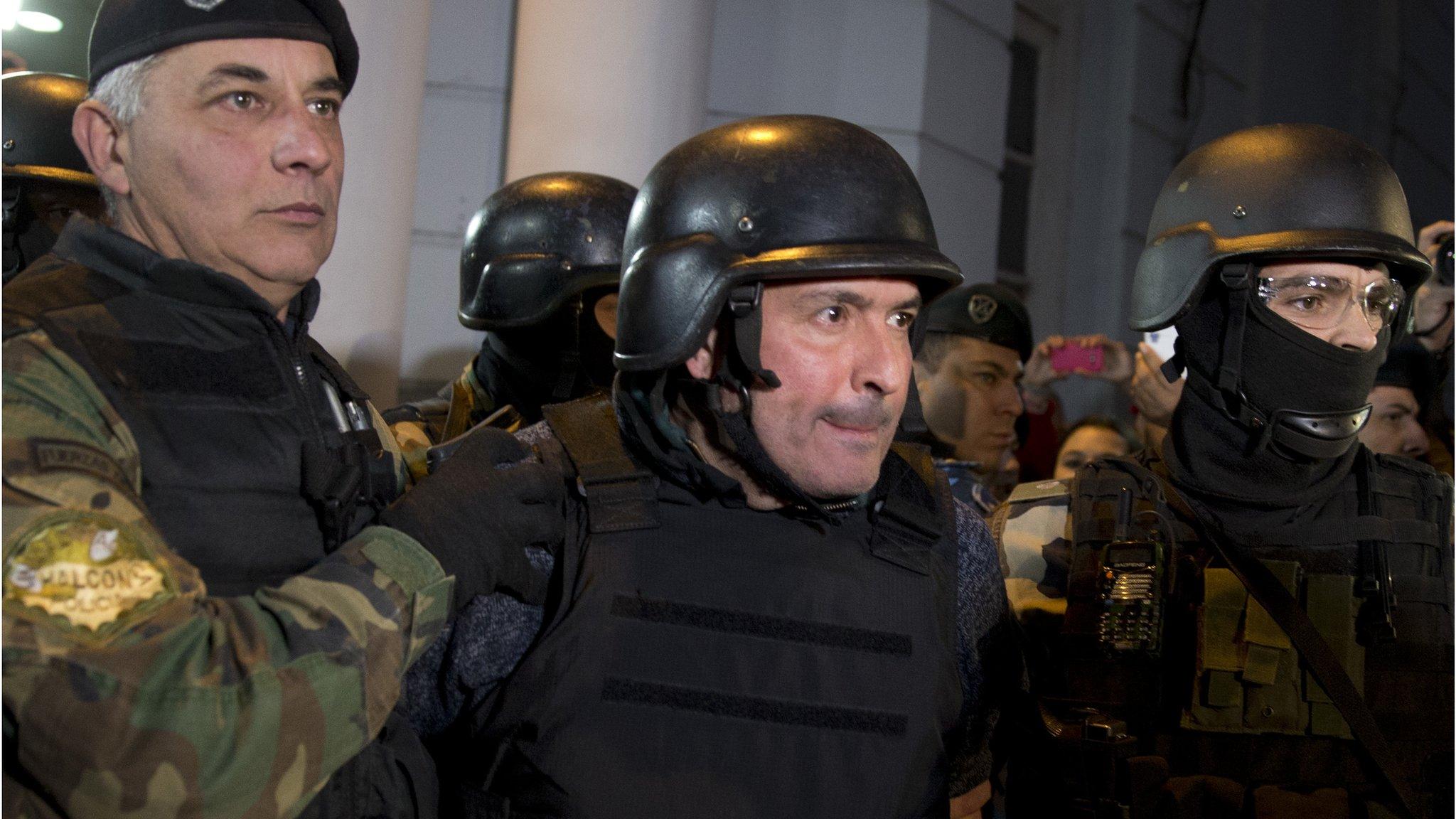 Jose Lopez, centre, escorted by police outside station in outskirts of Buenos Aires, Argentina, Tuesday, June 14, 2016