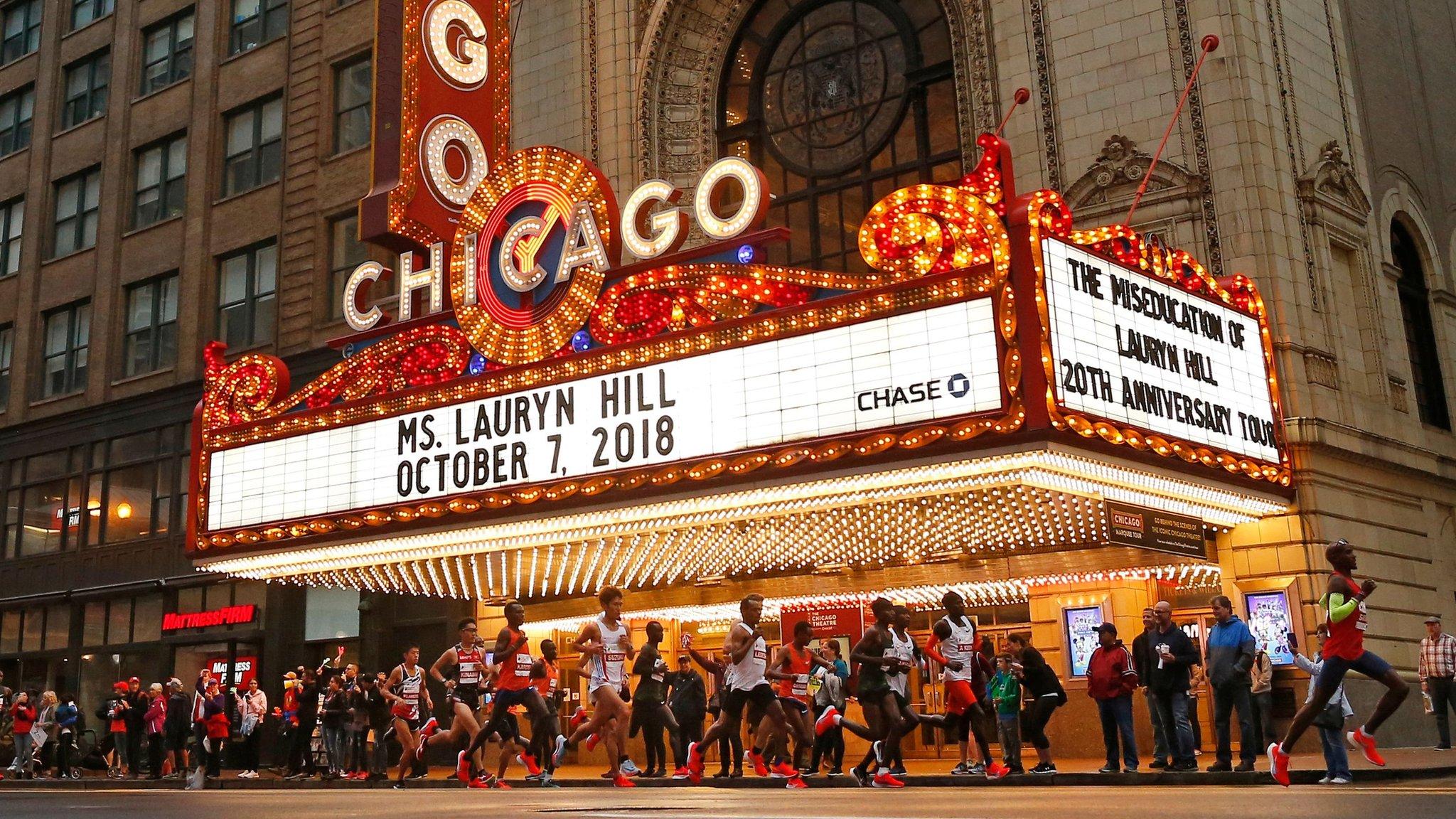 Chicago, United States, October 7: Great Britain's Mo Farah leads a group of runners past the Chicago Theatre during the Chicago Marathon. Farah set a new European record as he secured his first marathon win. (Photo by Jim Young/AFP/Getty)