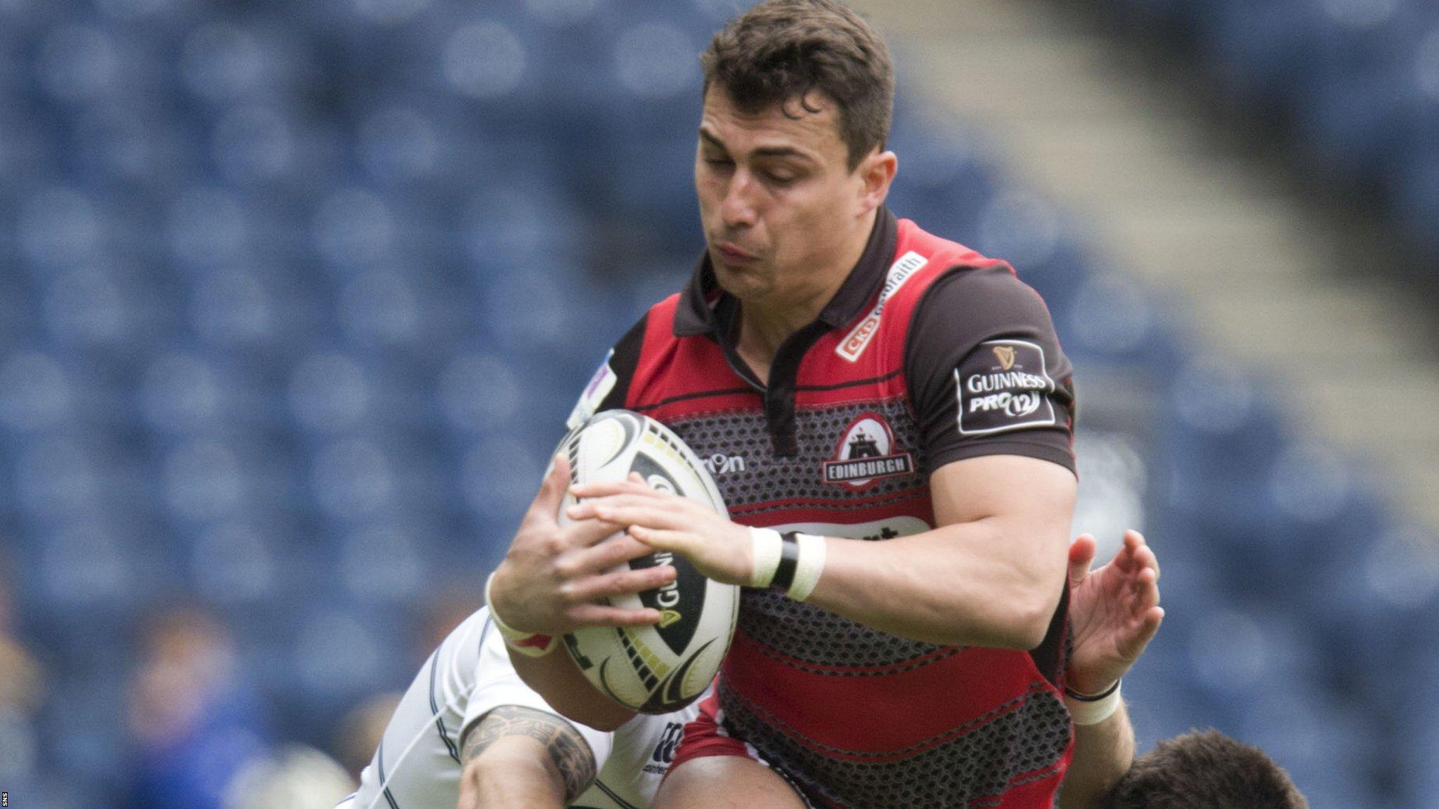 Damien Hoyland runs with the ball for Edinburgh against Cardiff Blues