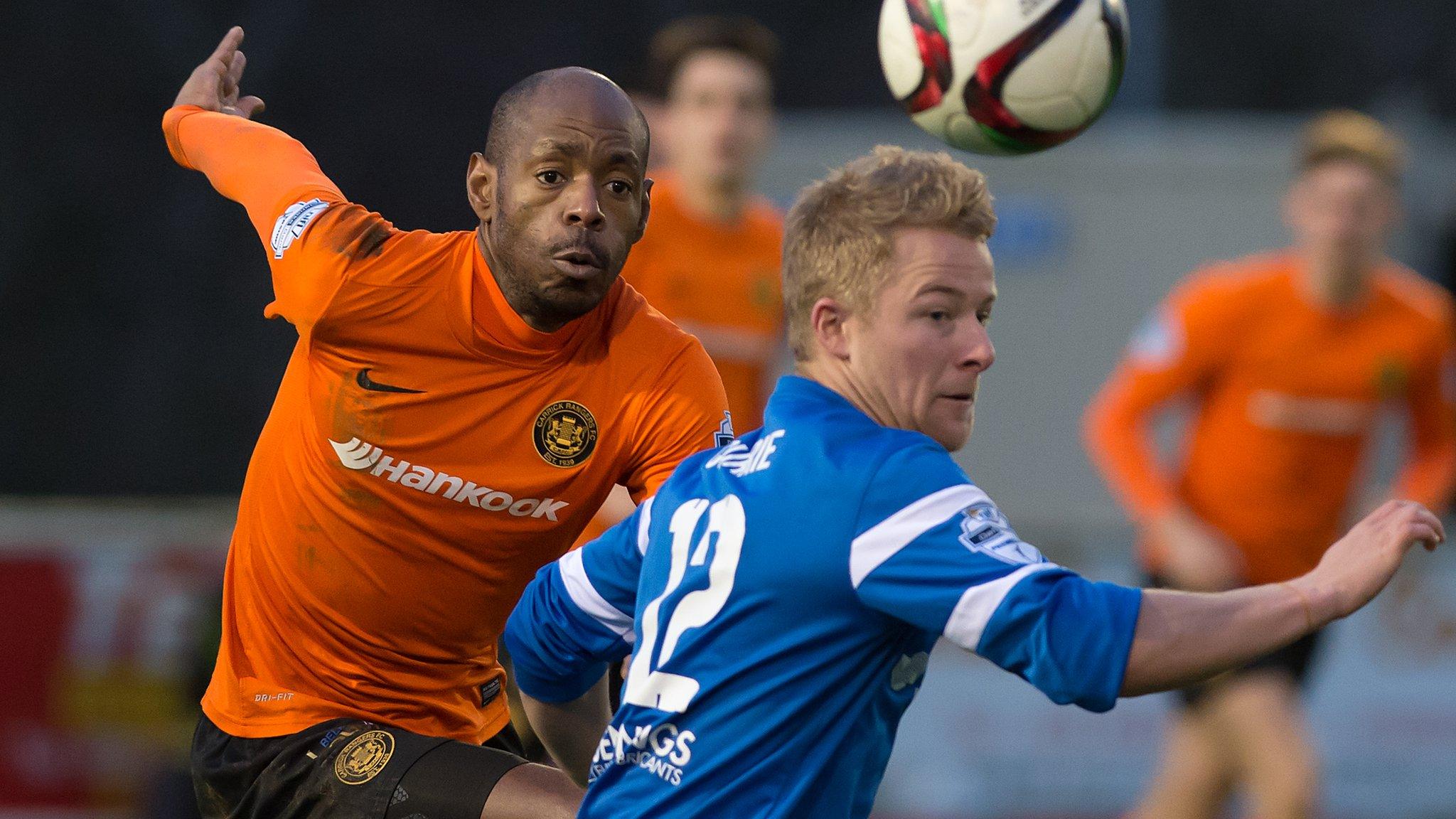 Carrick forward Miguel Chines challenge's Ballinamallard's John Currie