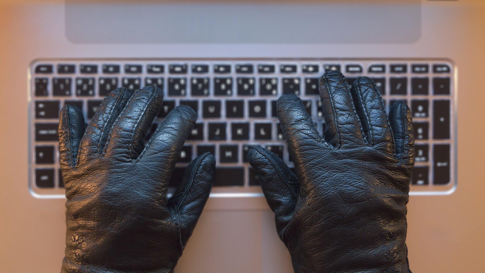 black gloves on computer keyboard