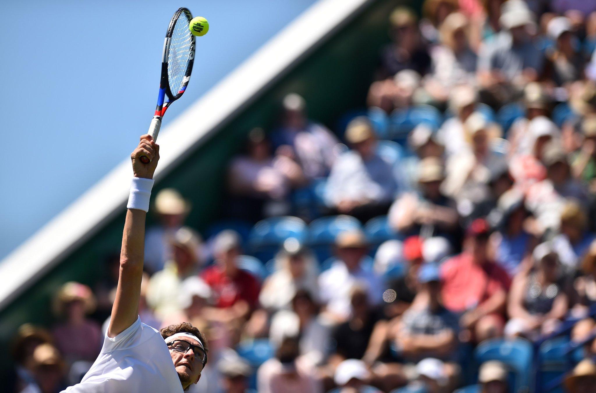 Uzbekistan's Denis Istomin serves against Italy's Andreas Seppi during a men's singles first round match at the ATP Nature Valley International tennis tournament in Eastbourne, southern England on June 25, 2018. (Photo by Glyn Kirk/AFP)