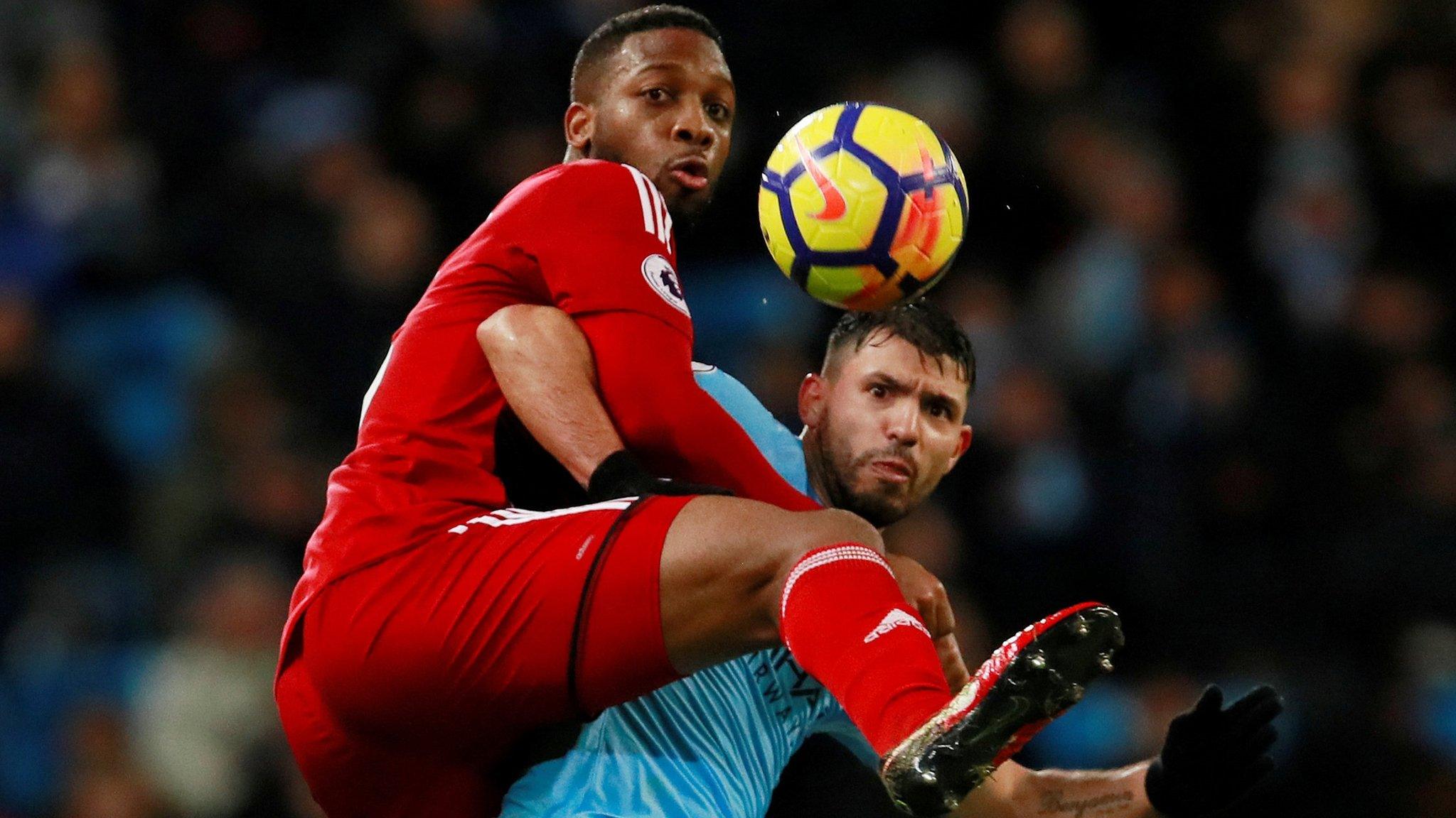 Watford's Molla Wague tangles with Manchester City's Sergio Aguero in City's 3-1 win on Tuesday