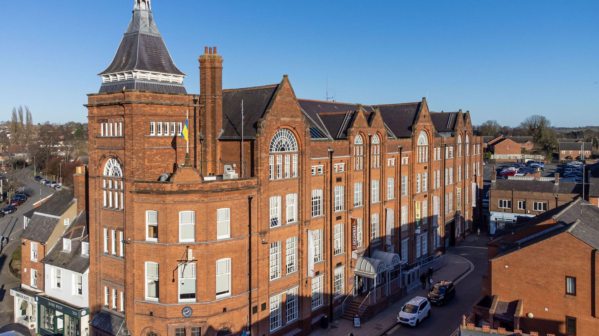A red-brick Victorian-style large former factory